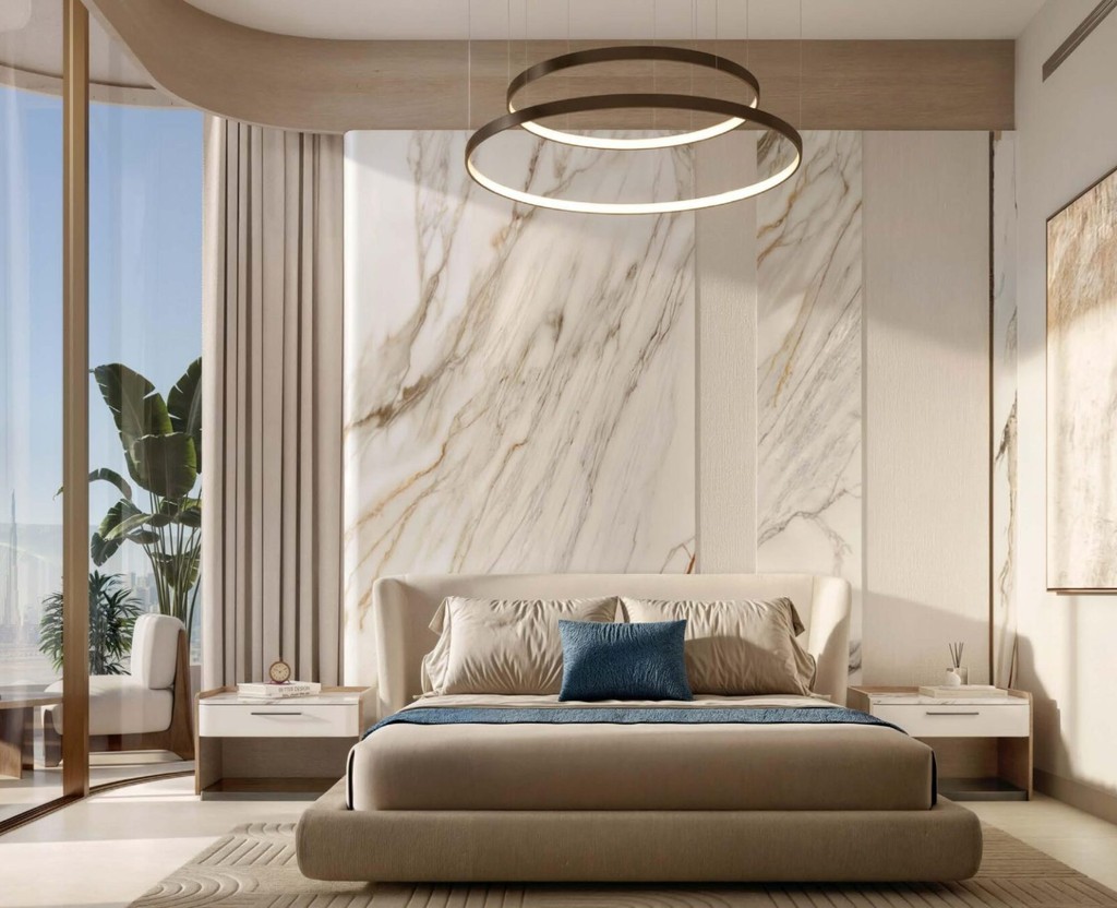 Contemporary bedroom with luxurious marble walls and flooring, located in Flora Shore Beachfront Residences.