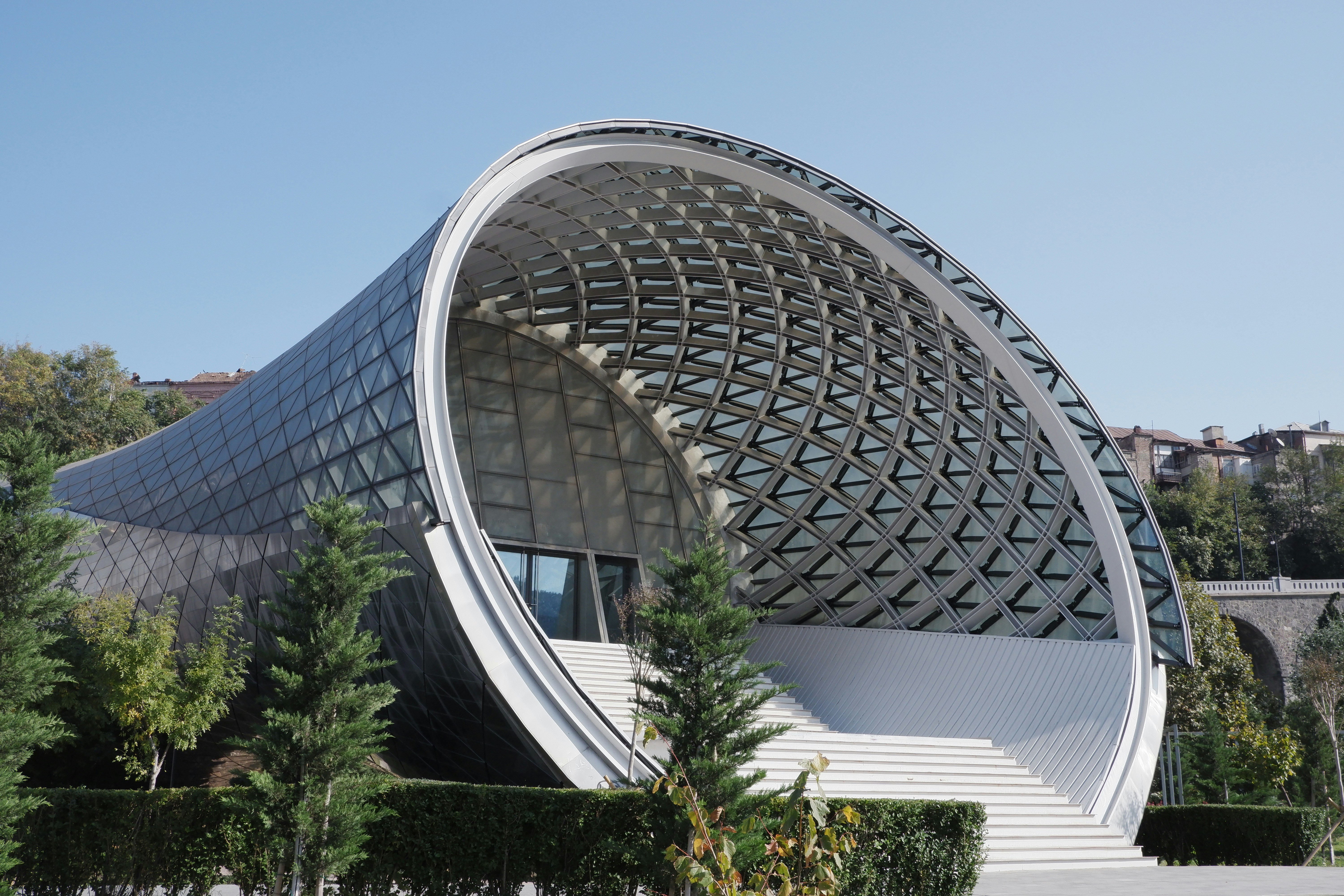 a large circular building with a staircase leading up to it