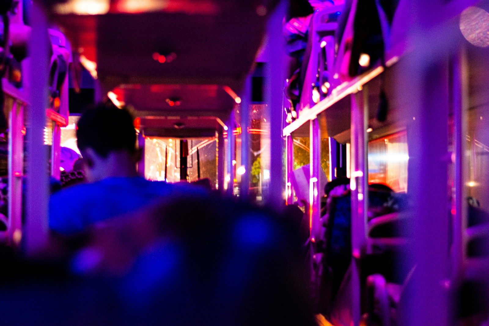 Passengers inside a party bus lit with purple lights