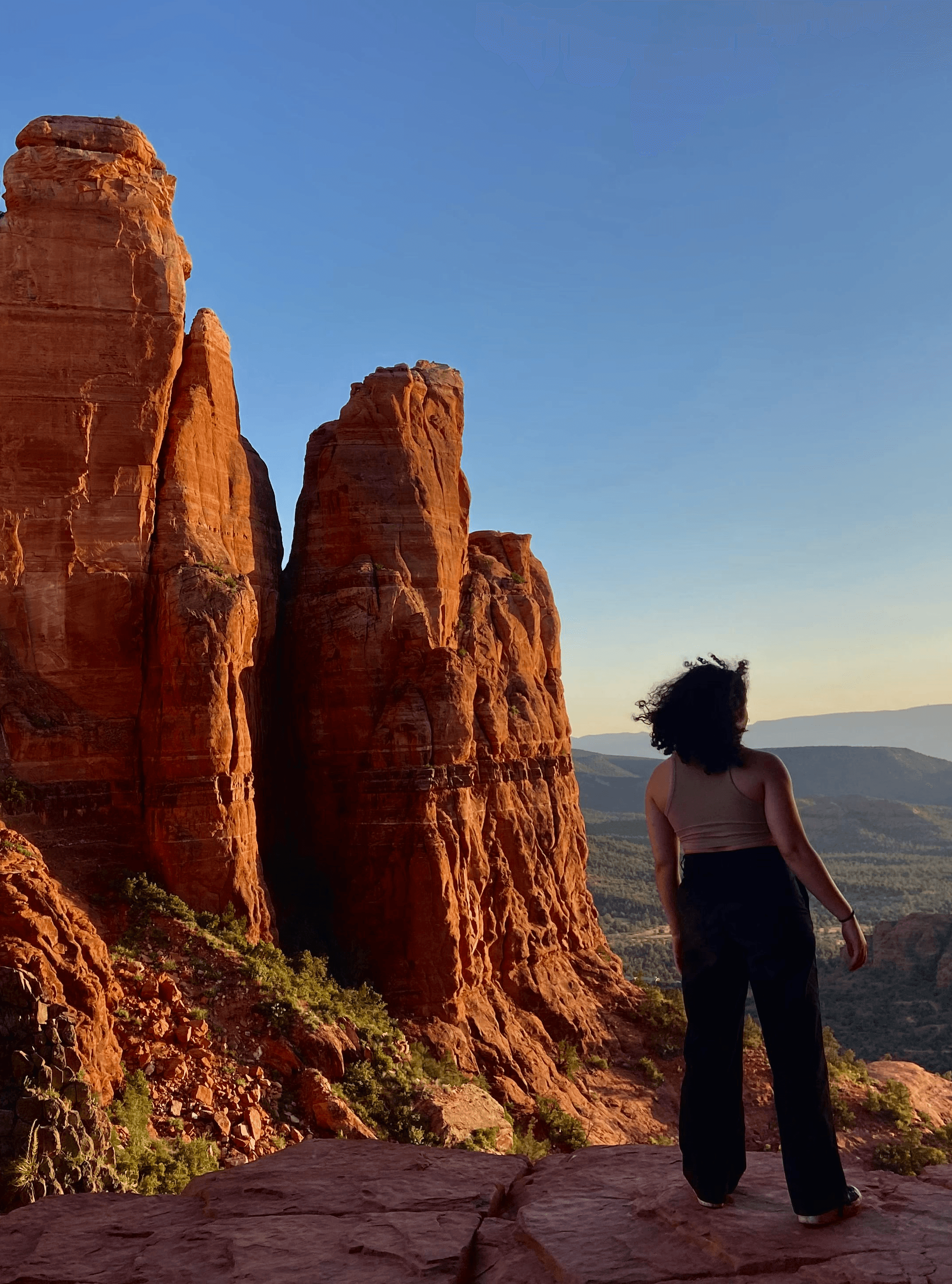 Kate standing on a desert cliff
