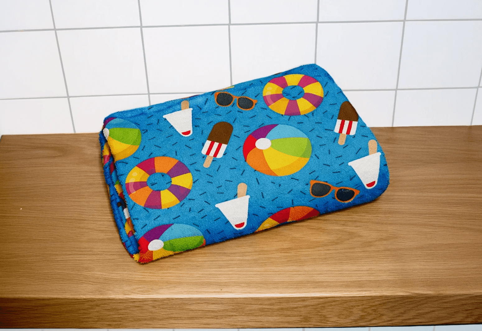 White branded cap with turquoise logo placed on fresh lemons in a red bowl