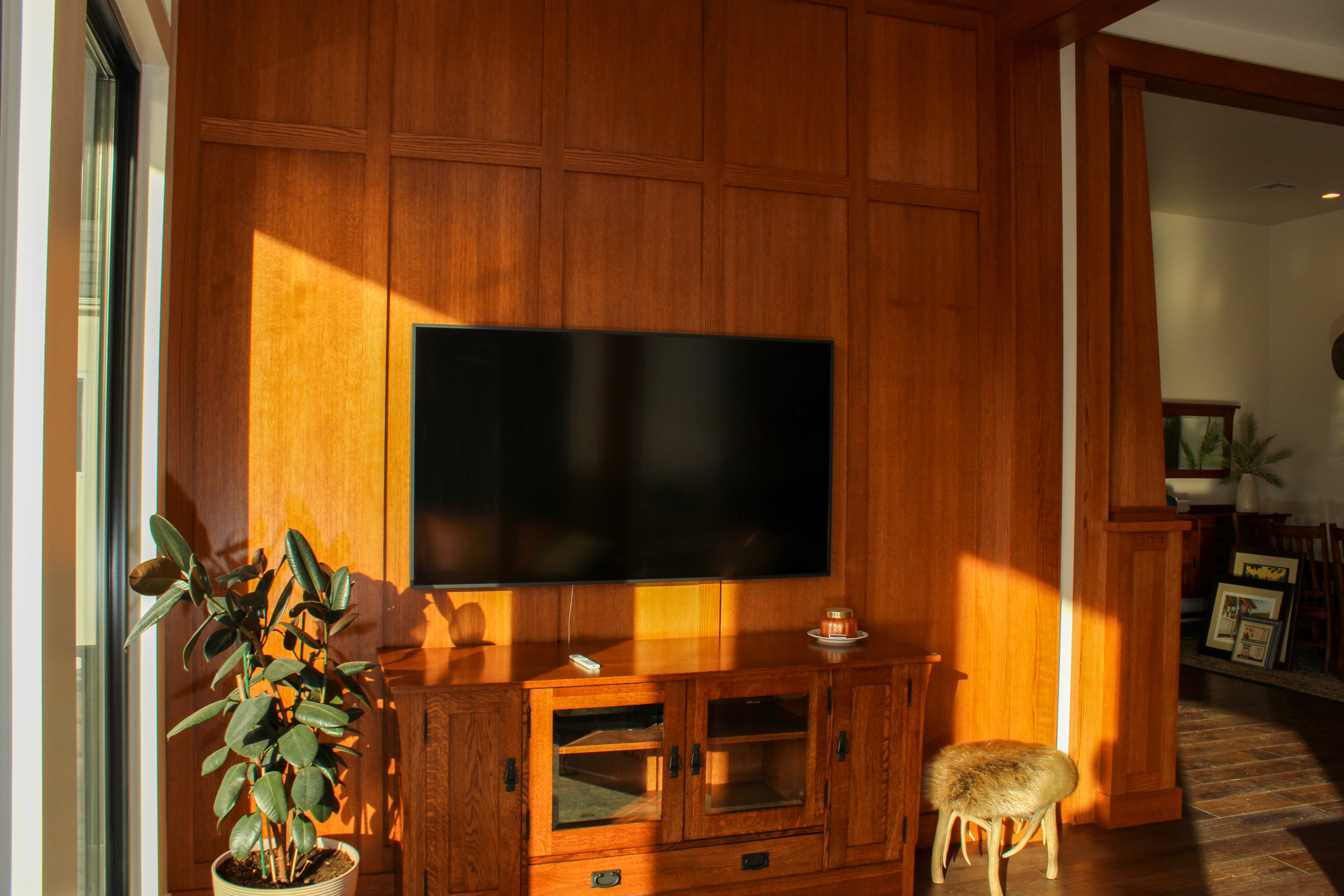 Great room in a St. George, Utah custom home with warm wood wall paneling in a 70's inspired design.