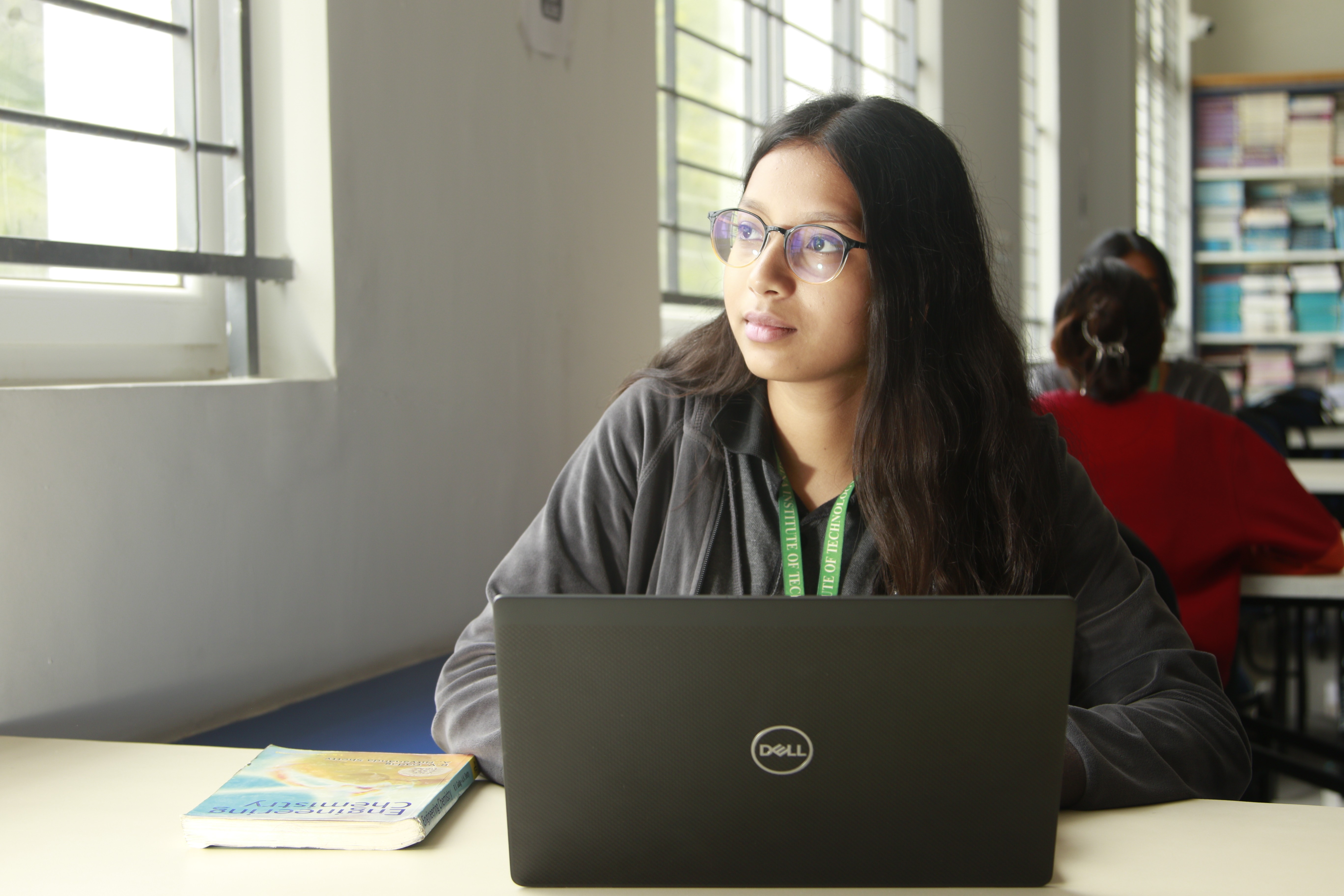 woman in black shirt holding green and blue plastic toy