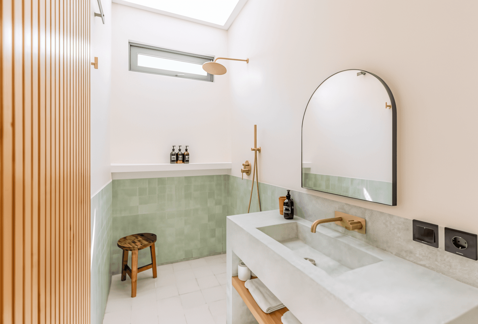 Modern bathroom with walk-in shower and stone finishes. Dedicated real estate support for Bali property buyers.