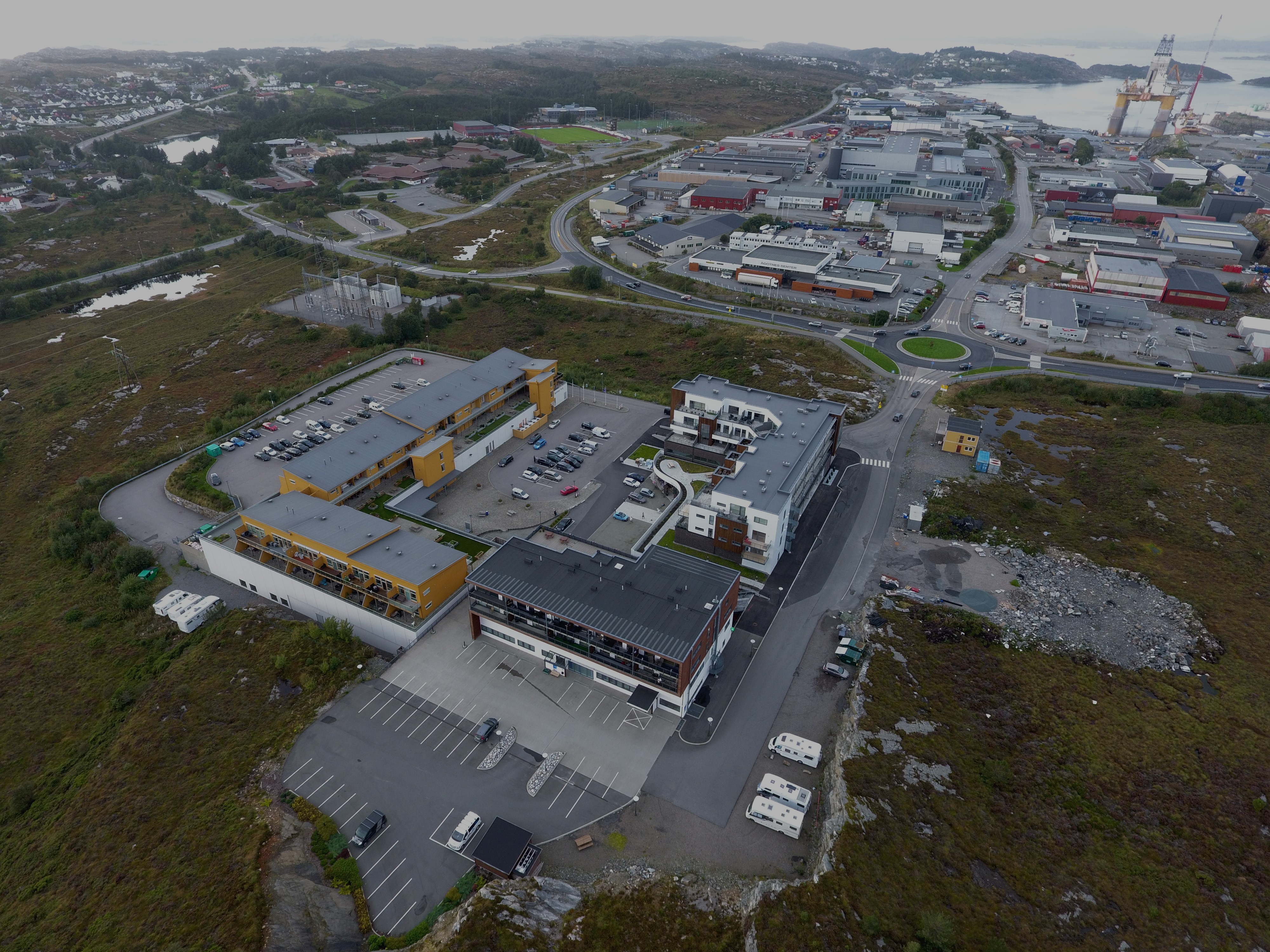 Business team collaborating in meeting room with whiteboard and notes on wall and table.