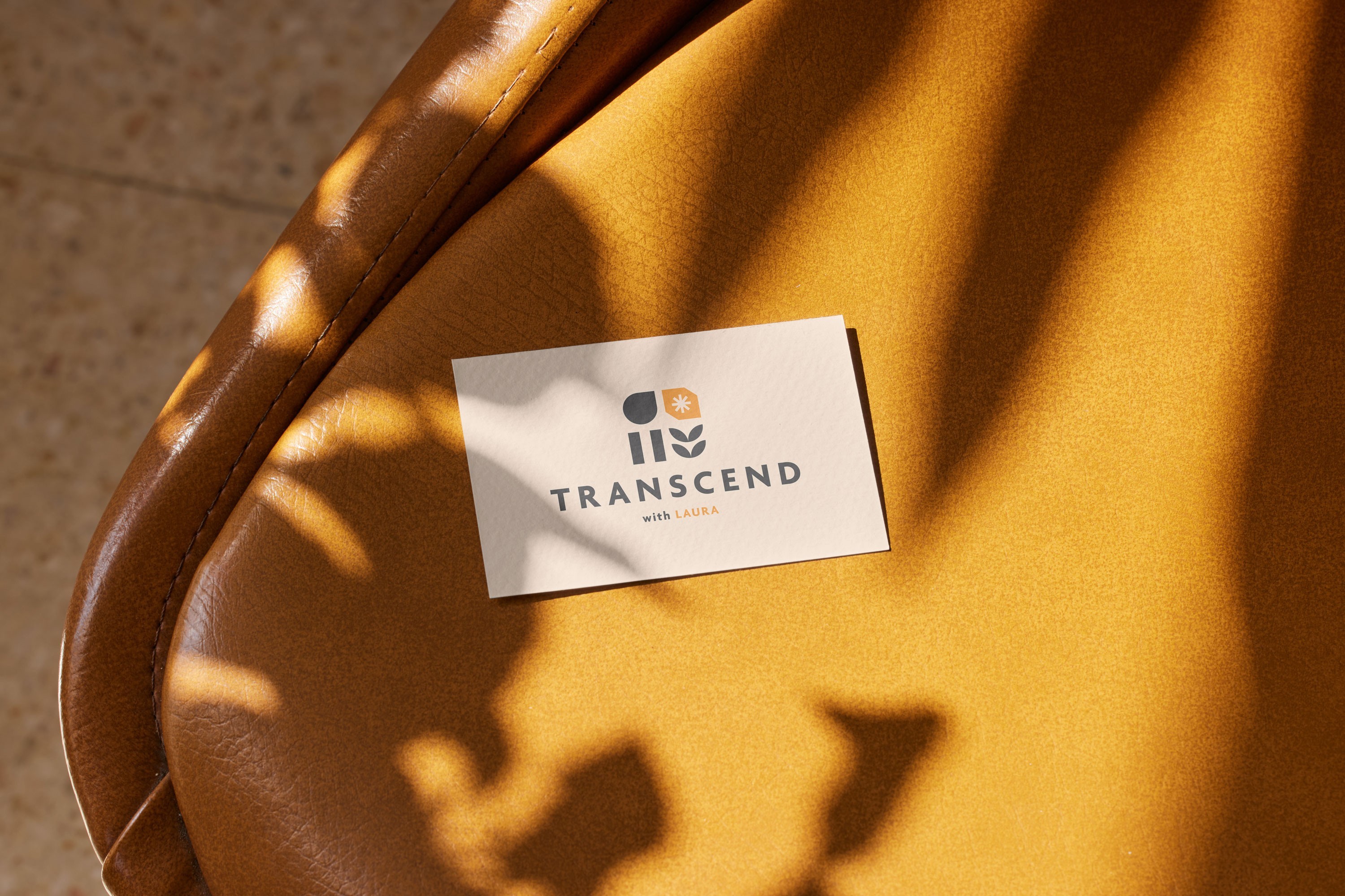 Business card with "TRANSCEND with LAURA" text
