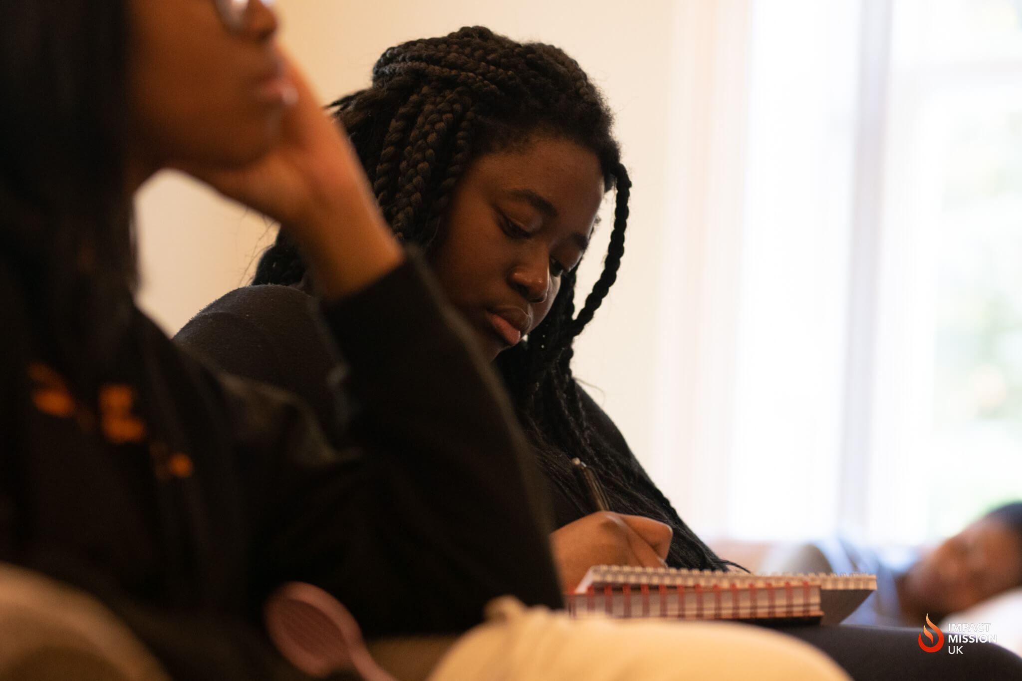 Woman making notes in the Life Group session