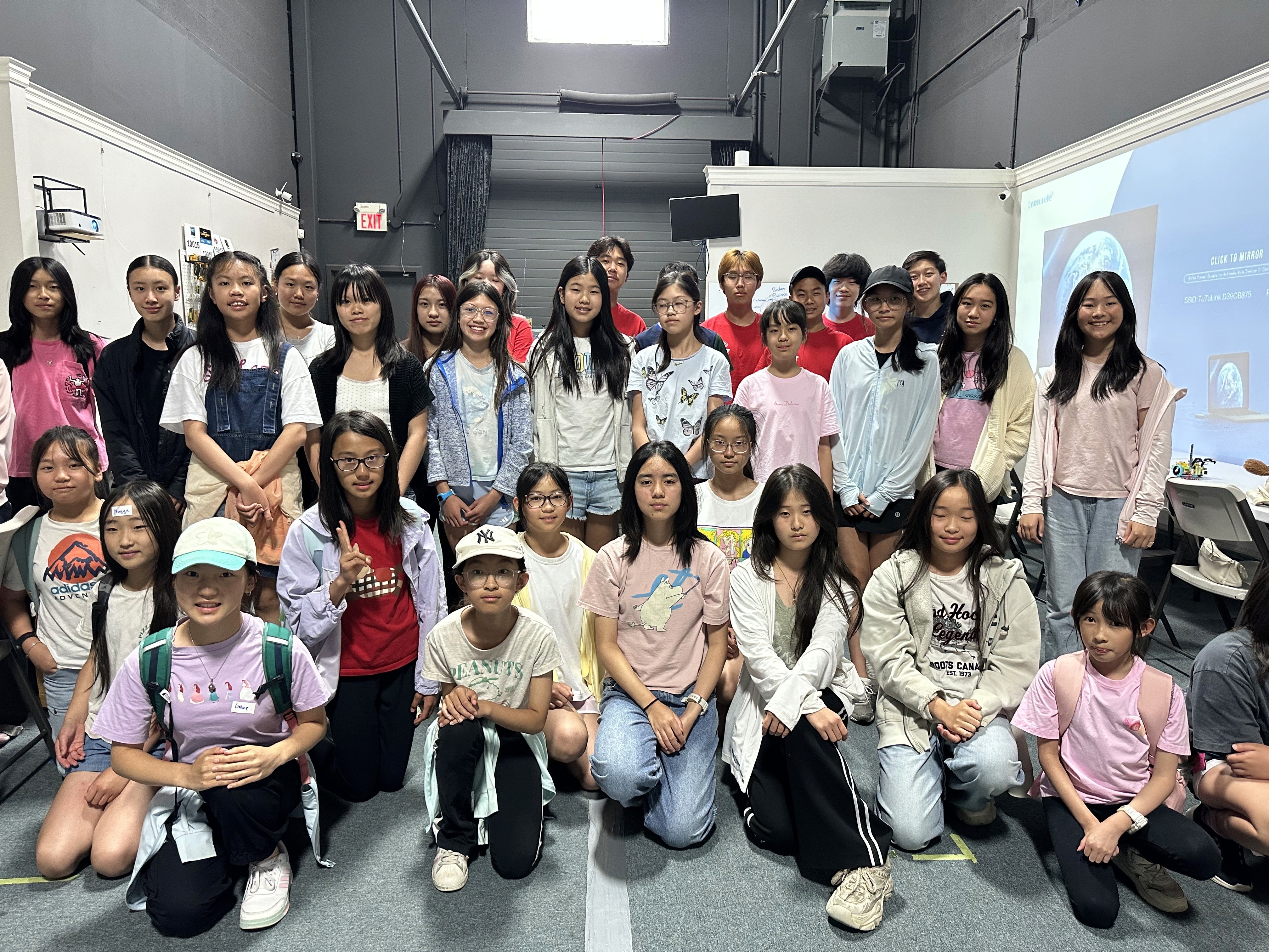 Twenty-six girls attending a free FIRST Robotics Canada summer camp delivered by FRC Team 10015 Bubbles at SolversMind Robotics in Aurora, Ontario