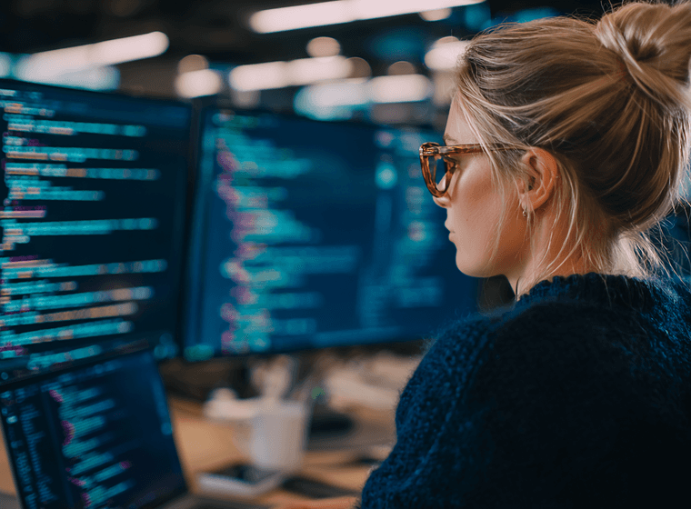 Developer coding on multiple screens