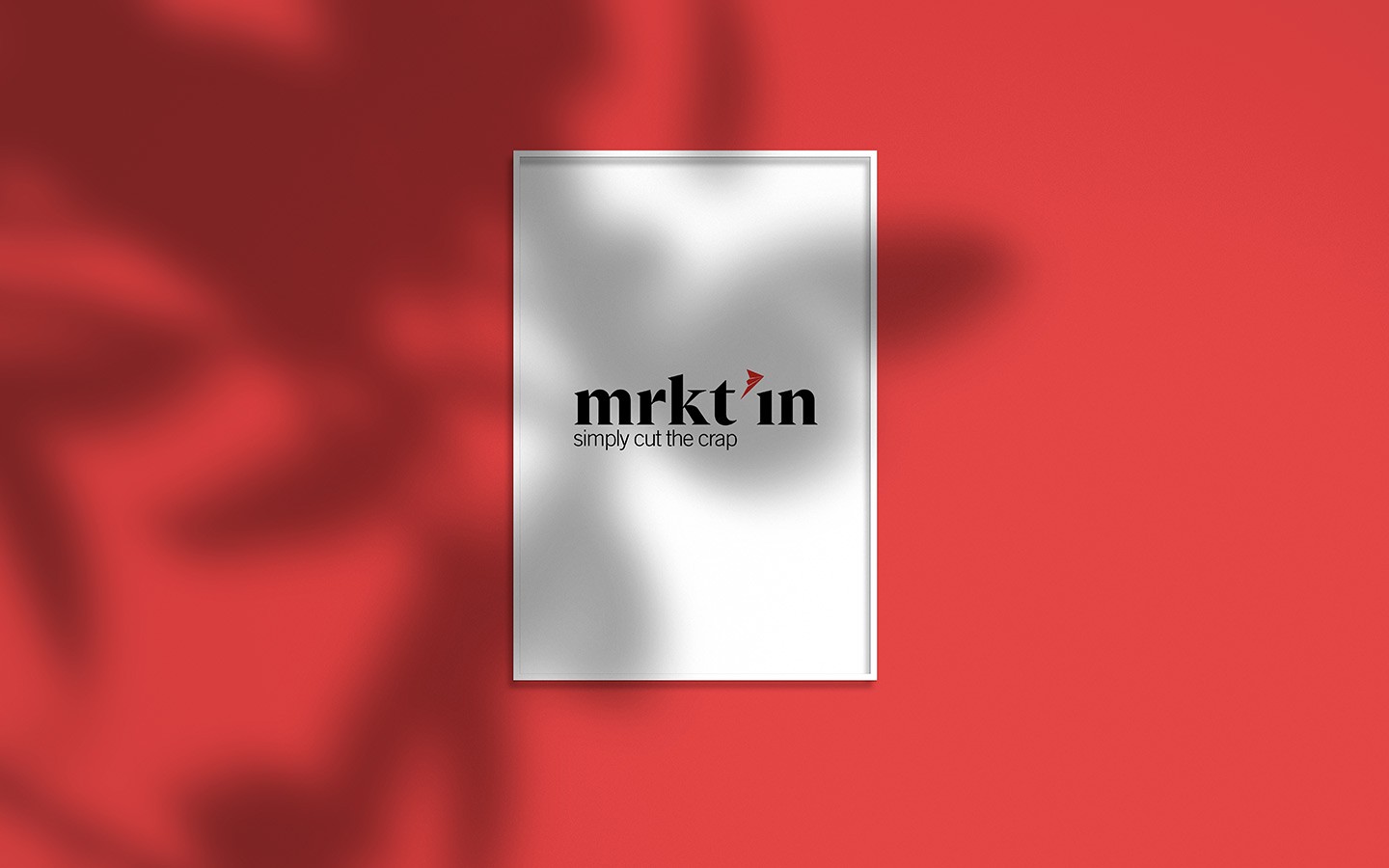 Poster in frame on red background, tree shadow.