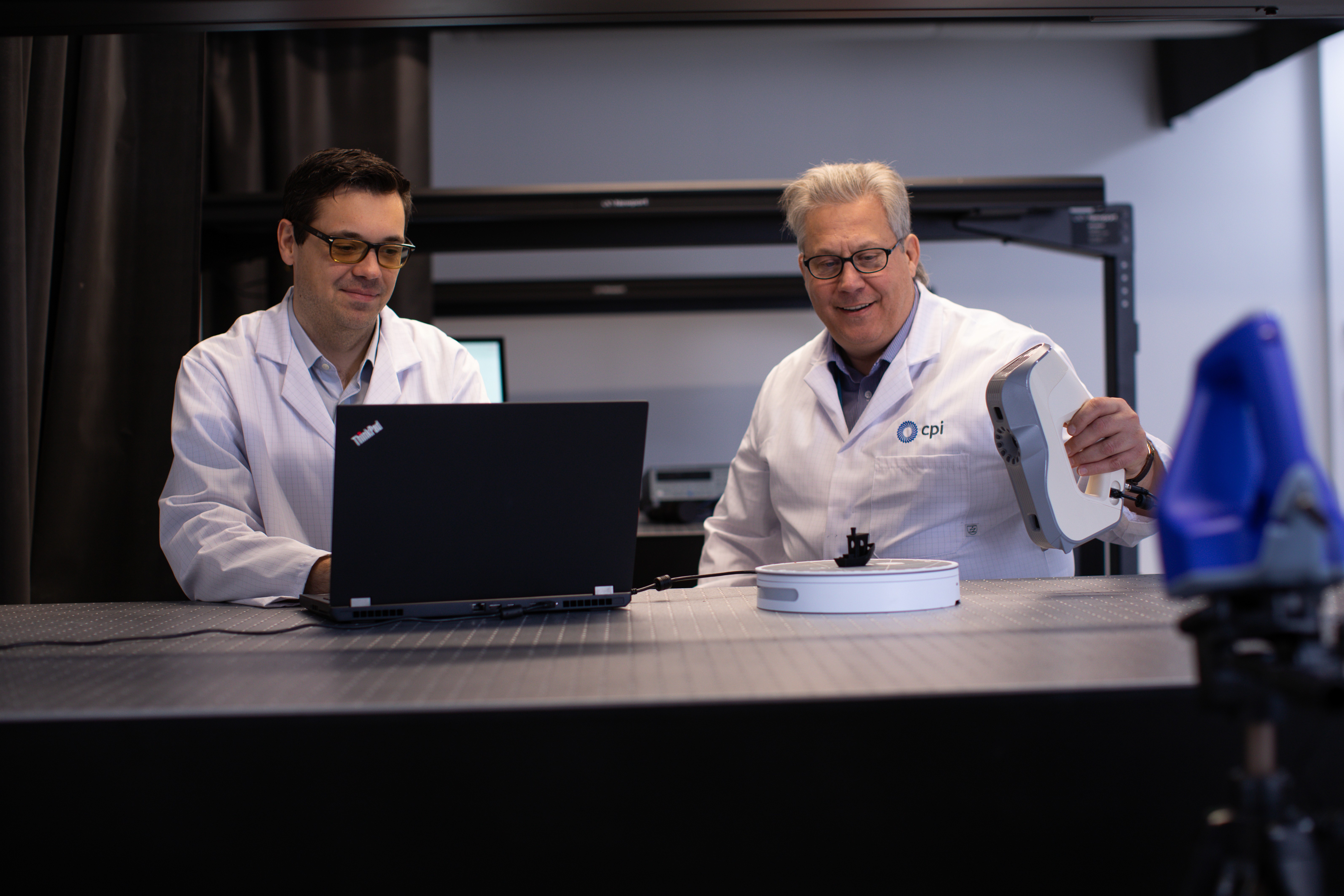 Two CPI scientists examining a 3D printed element.