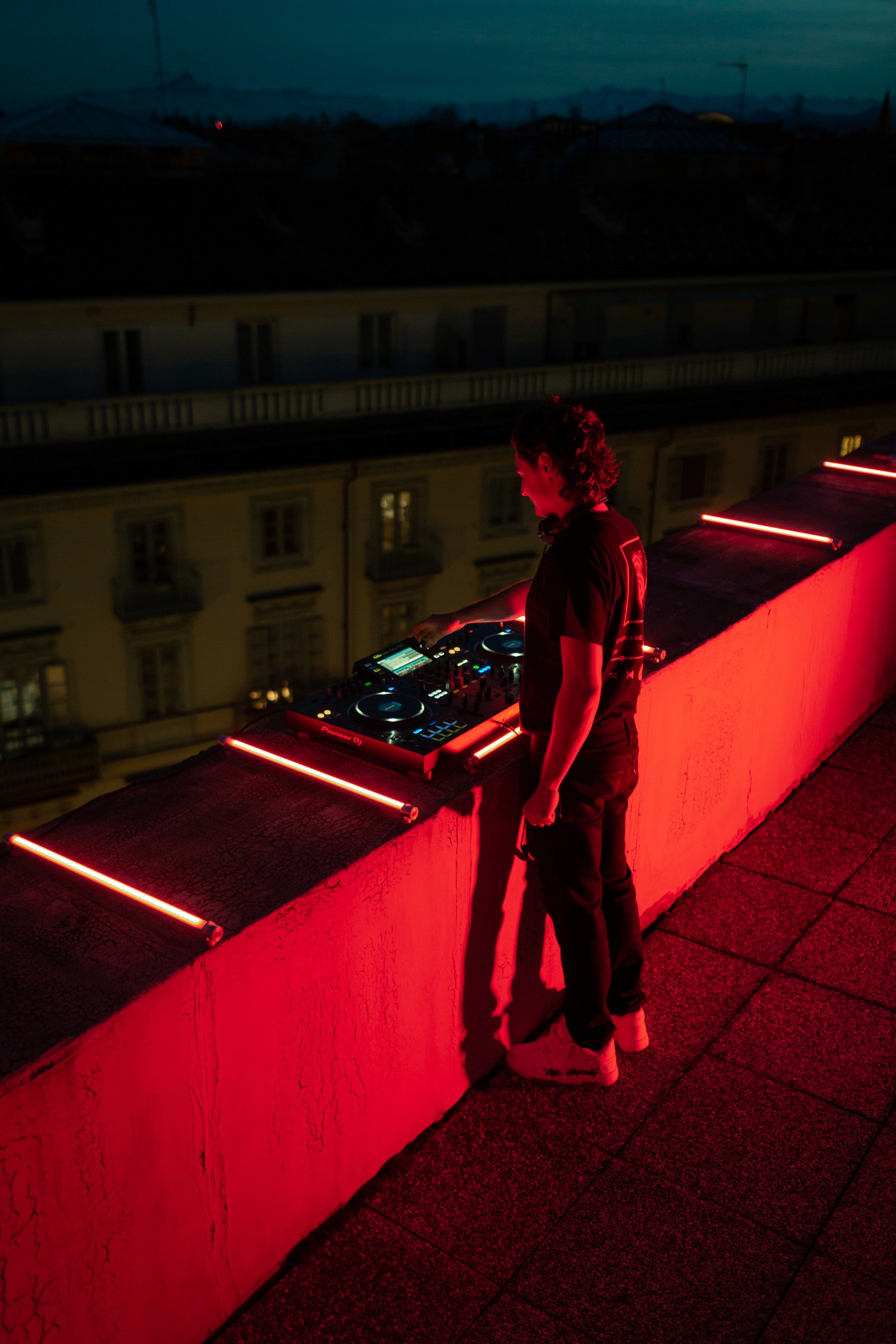 red picture of a DJ in Torino Disco Event