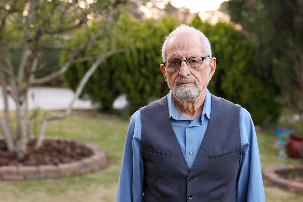 Bubjan with book and speaking to camera