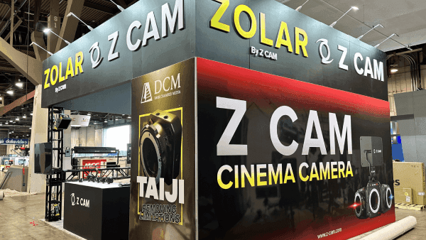 ZOLAR Z CAM NAB Show 20x30 booth with large branded graphics wall, cinema camera display, screen-led product messaging, and broadcast demo layout