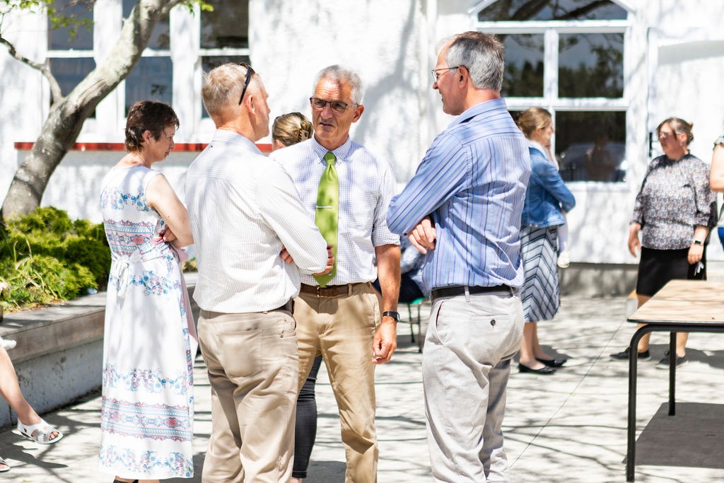 two women singing into microphones on a stage