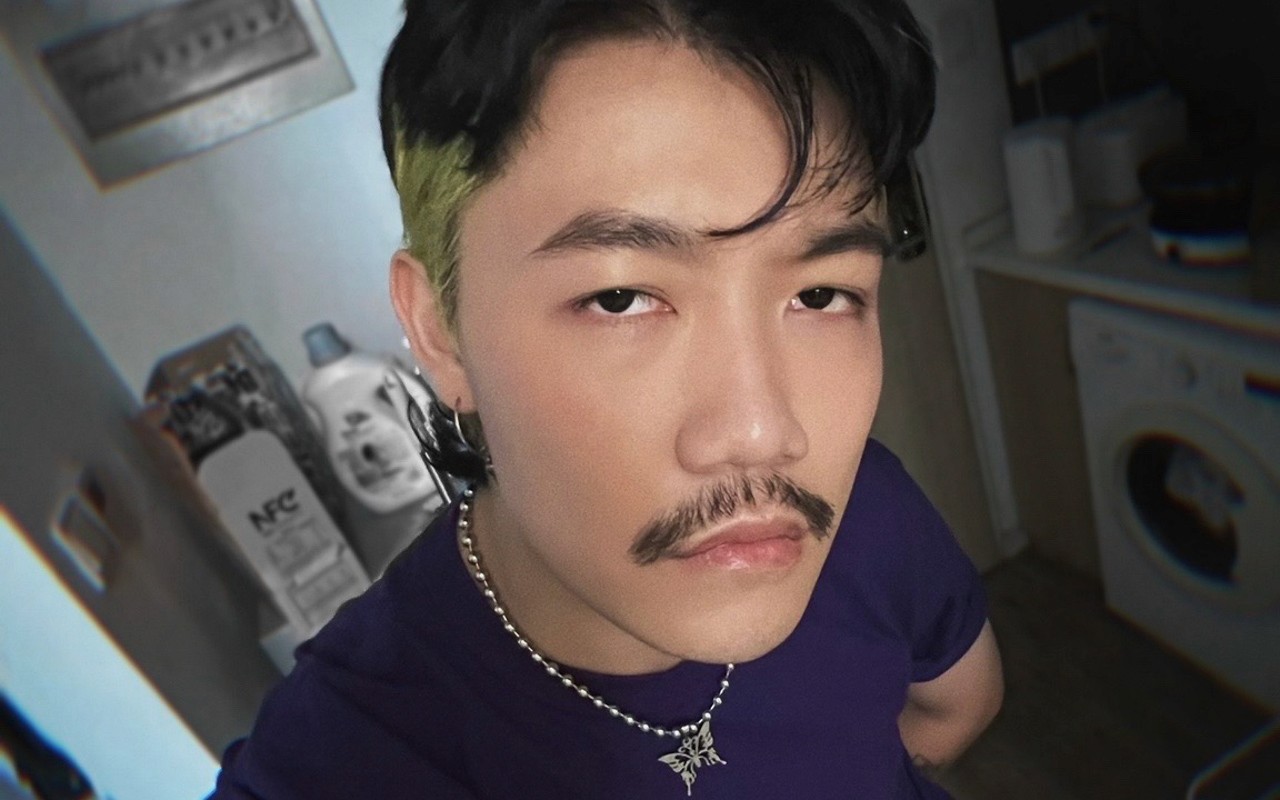 closeup of man with mustache looking at the camera