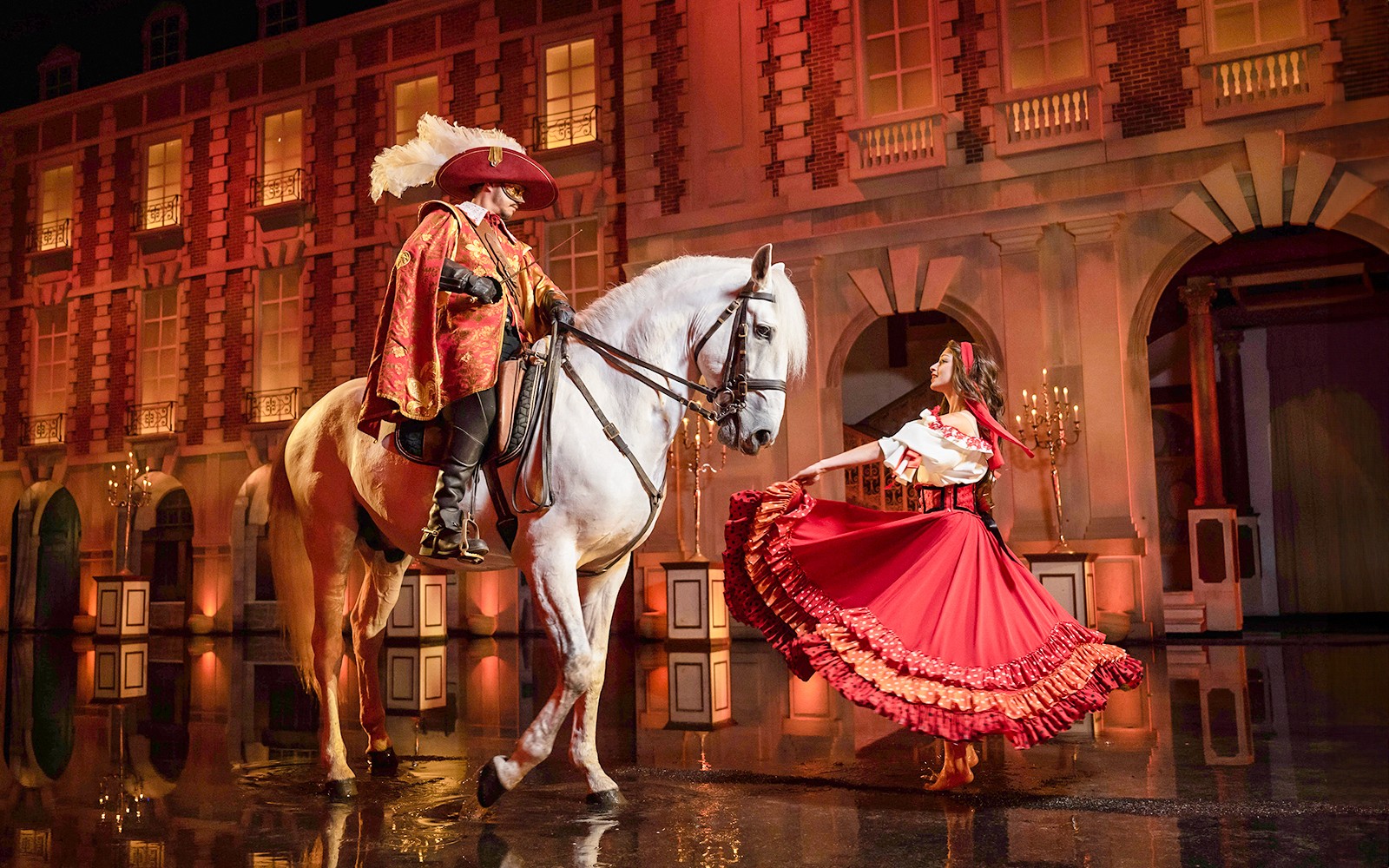 Performer on horseback and dancer in costume at Puy du Fou Theme Park show.
