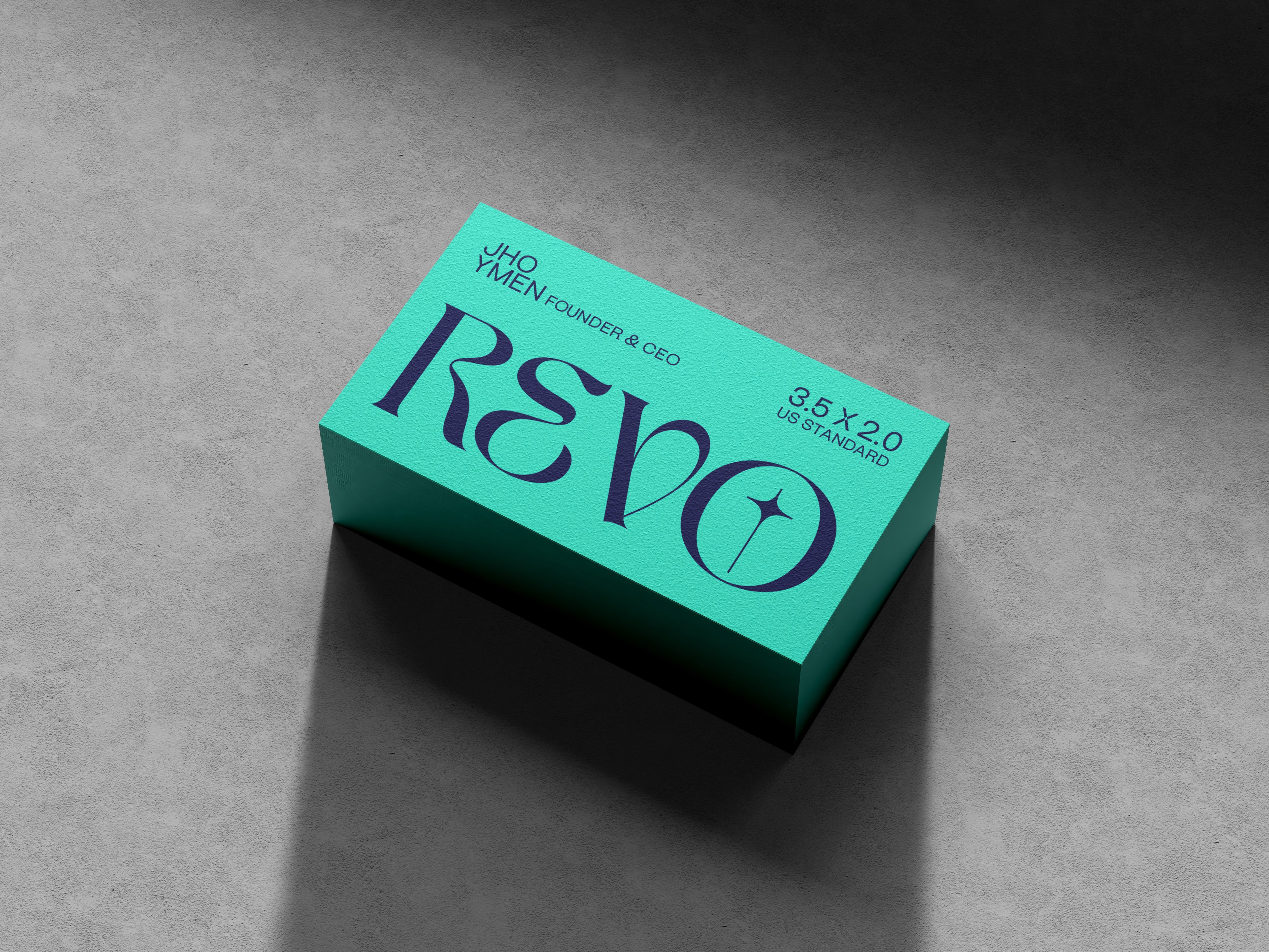 A premium teal blue brand box featuring "REVO" in elegant serif typography, placed on a clean grey concrete surface with soft shadows, illustrating scalable workflows and consistent design patterns.