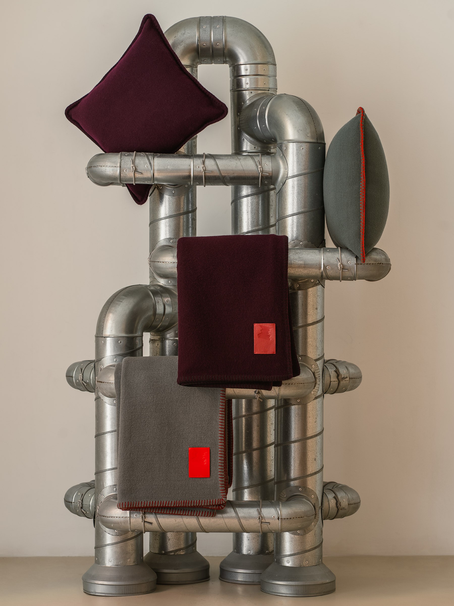Sculptural metal structure by Rafa Muñoz styled with Viso Project merino cushions and blankets.