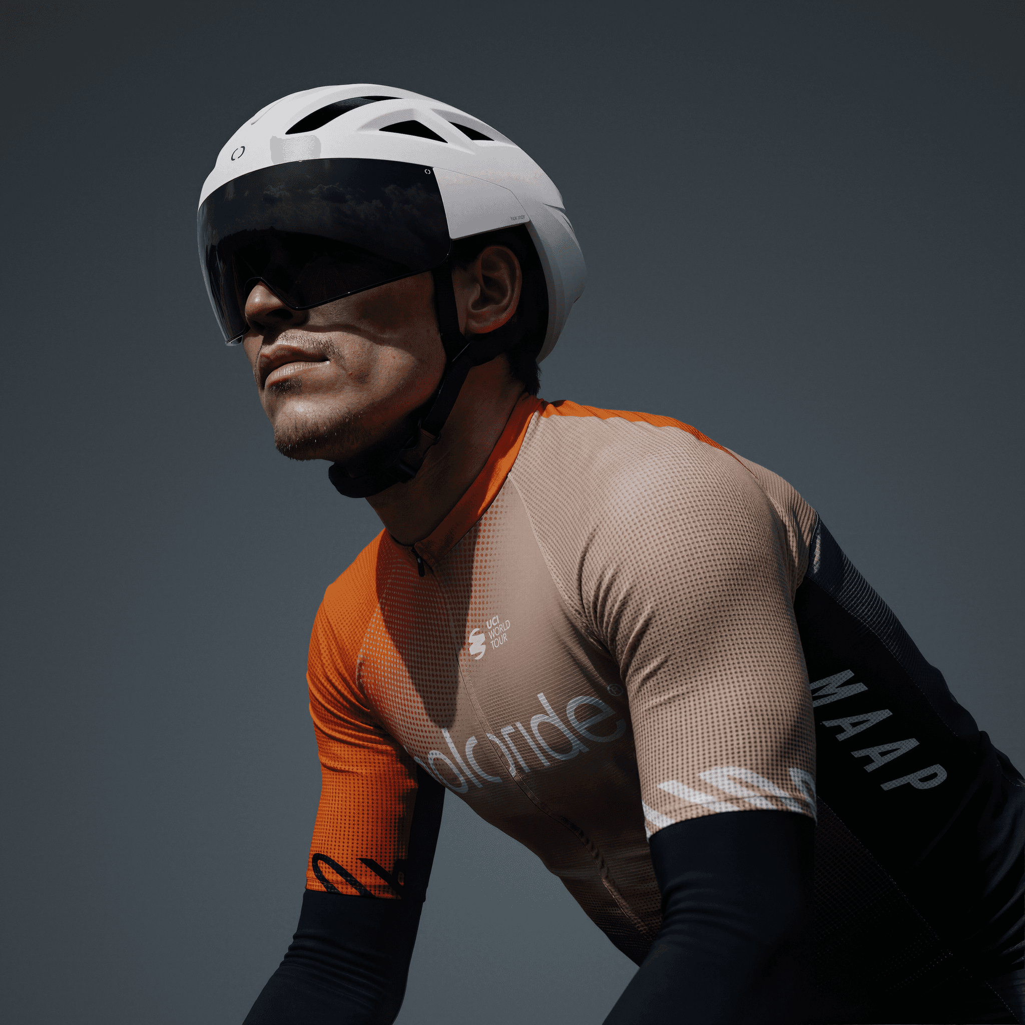 Holoride cyclist wearing a holoride helmet and branded jersey on a dark grey studio backdrop.