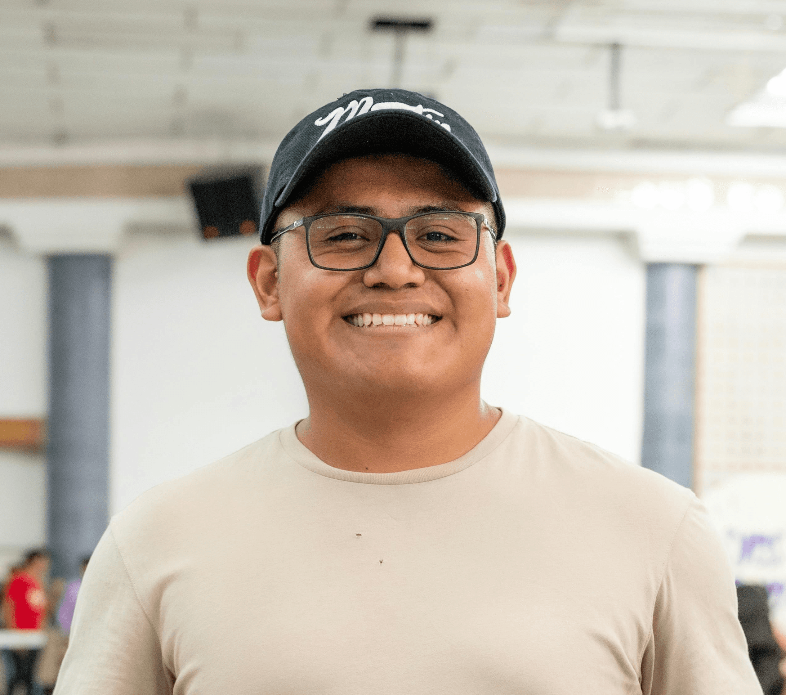Close-up portrait of a smiling man with curly brown hair