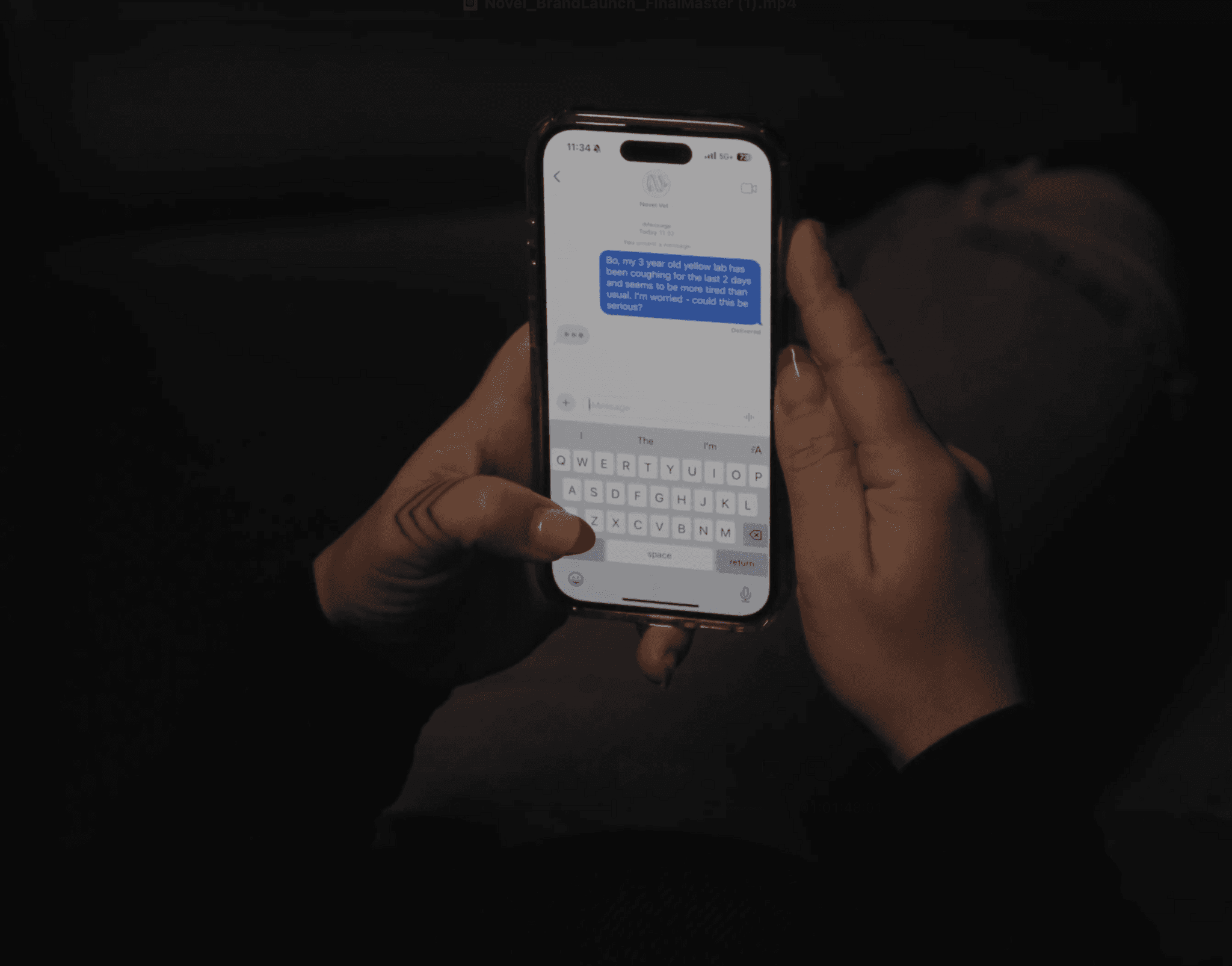 Hands holding a smartphone with a chat app at night