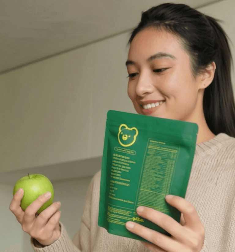 Plain cream tote bag hanging on a desert cactus plant.