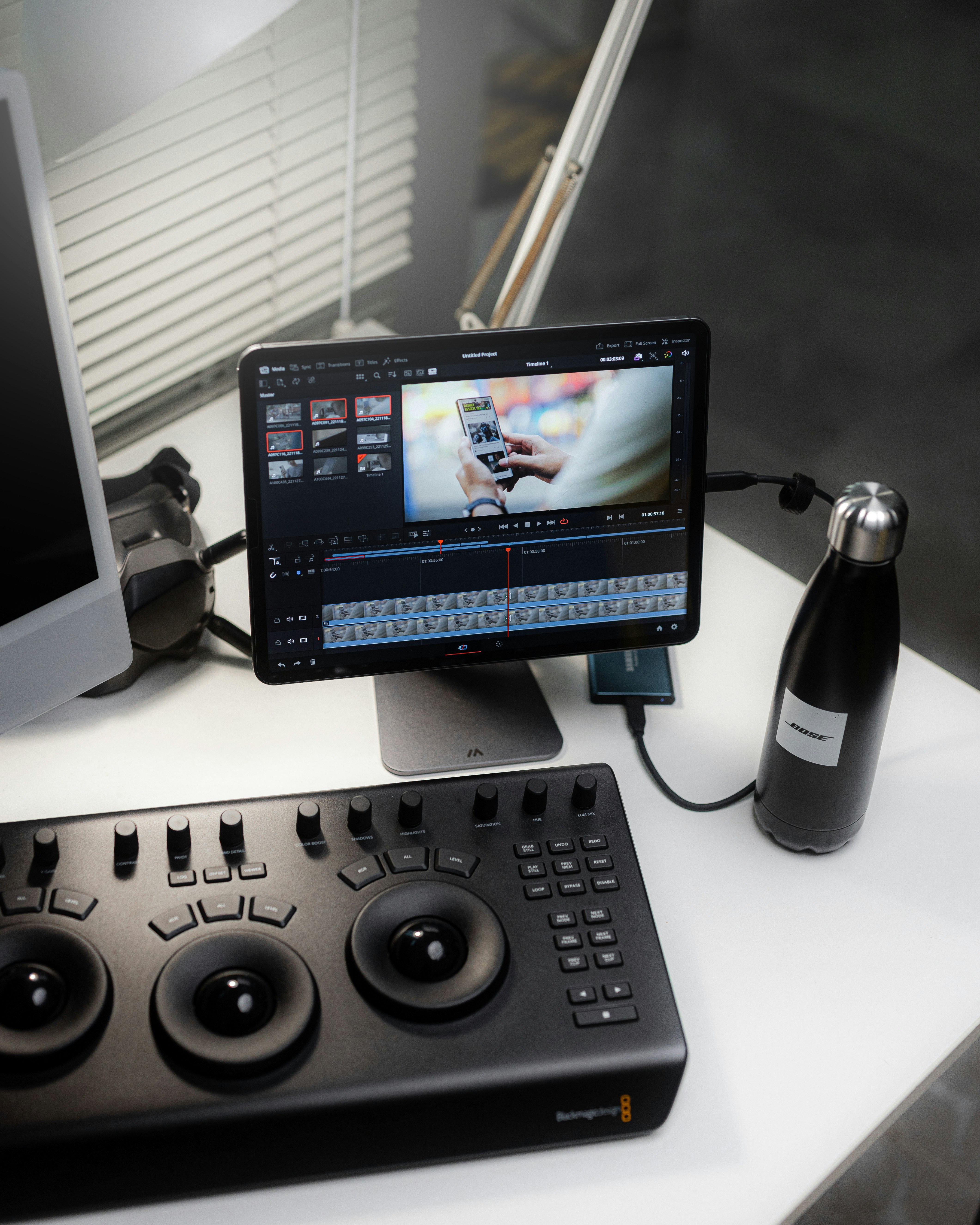 a desk with an ipad and water bottle