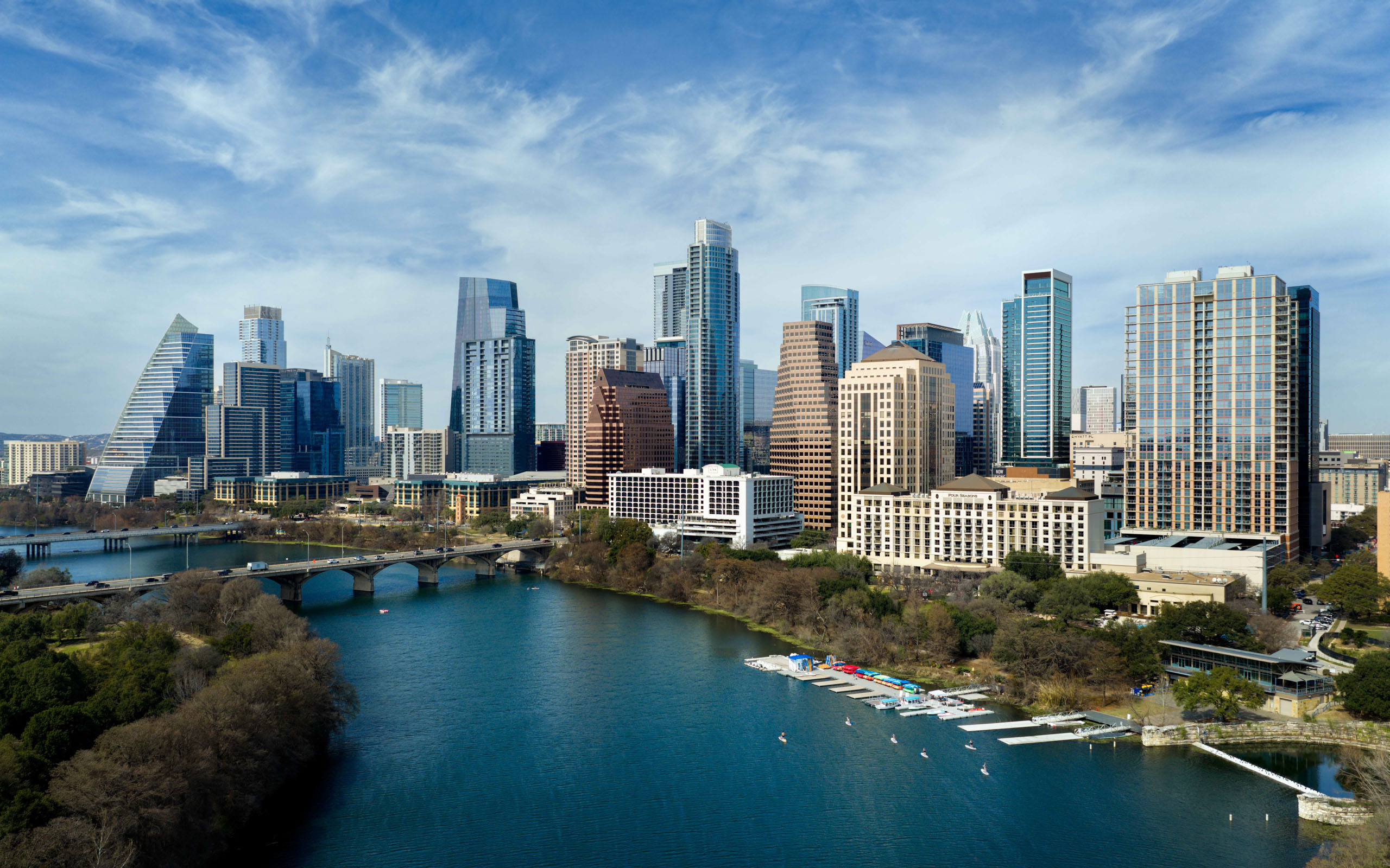 Austin skyline with bridges, river, and boats