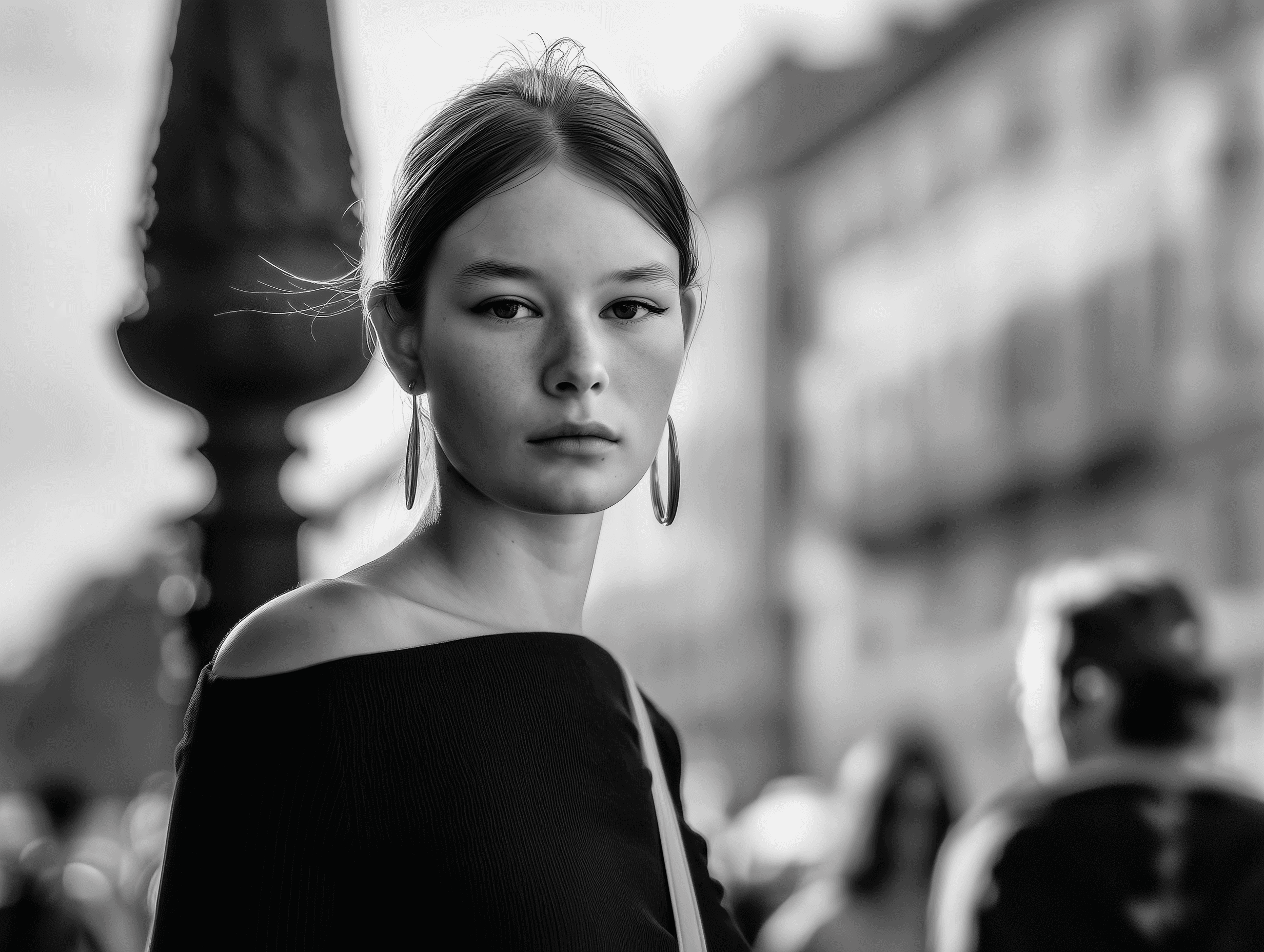 black and white photo of a girl in a european city