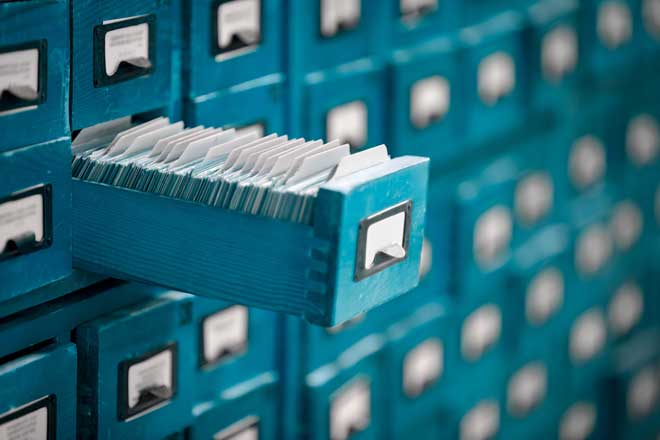 Rows and columns of file cabinets filled with reports.