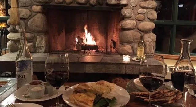 Image of Cozy interior design with wine, food, and fire, showcasing luxurious home builder KHD Homes' design.