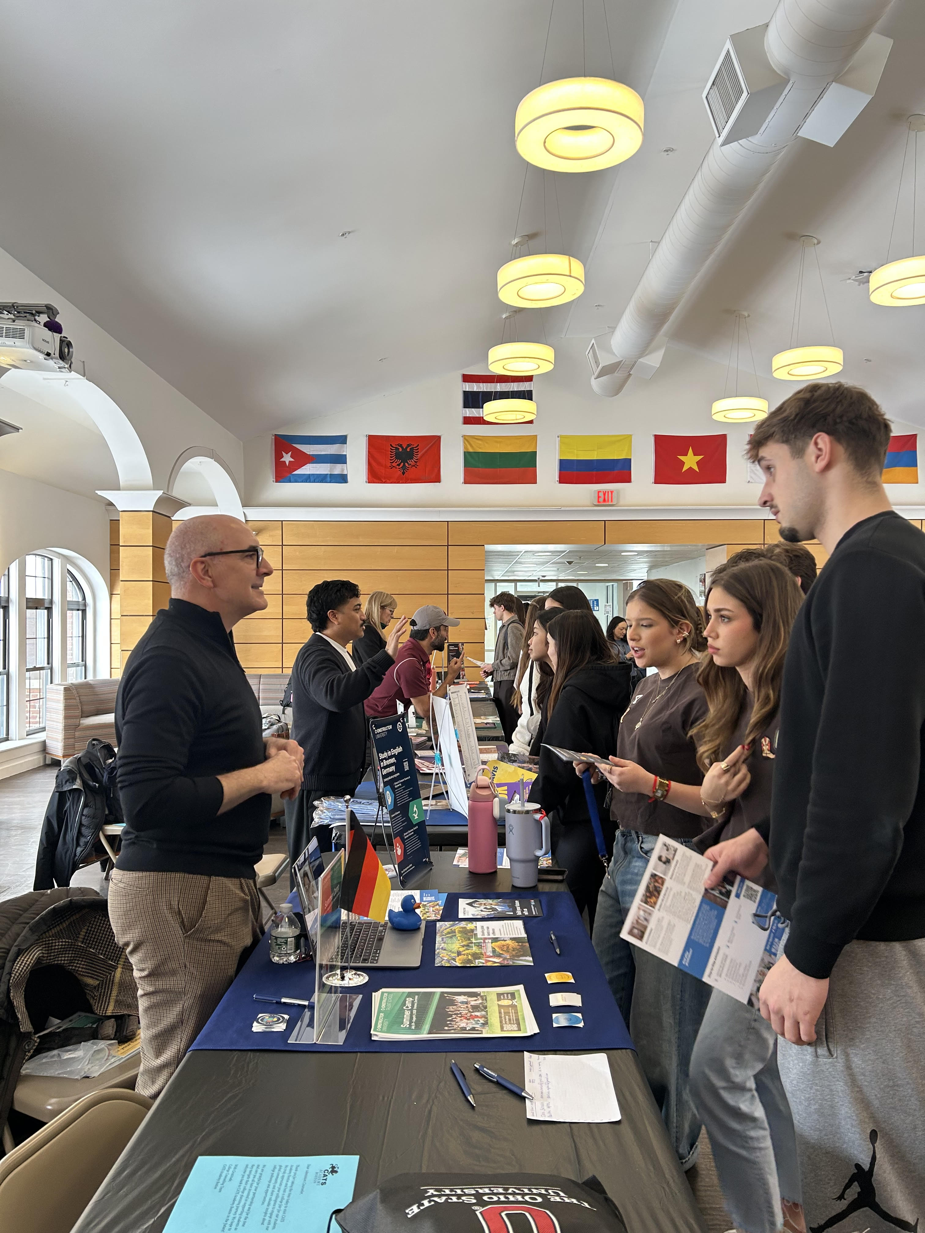 a university representative talking with students