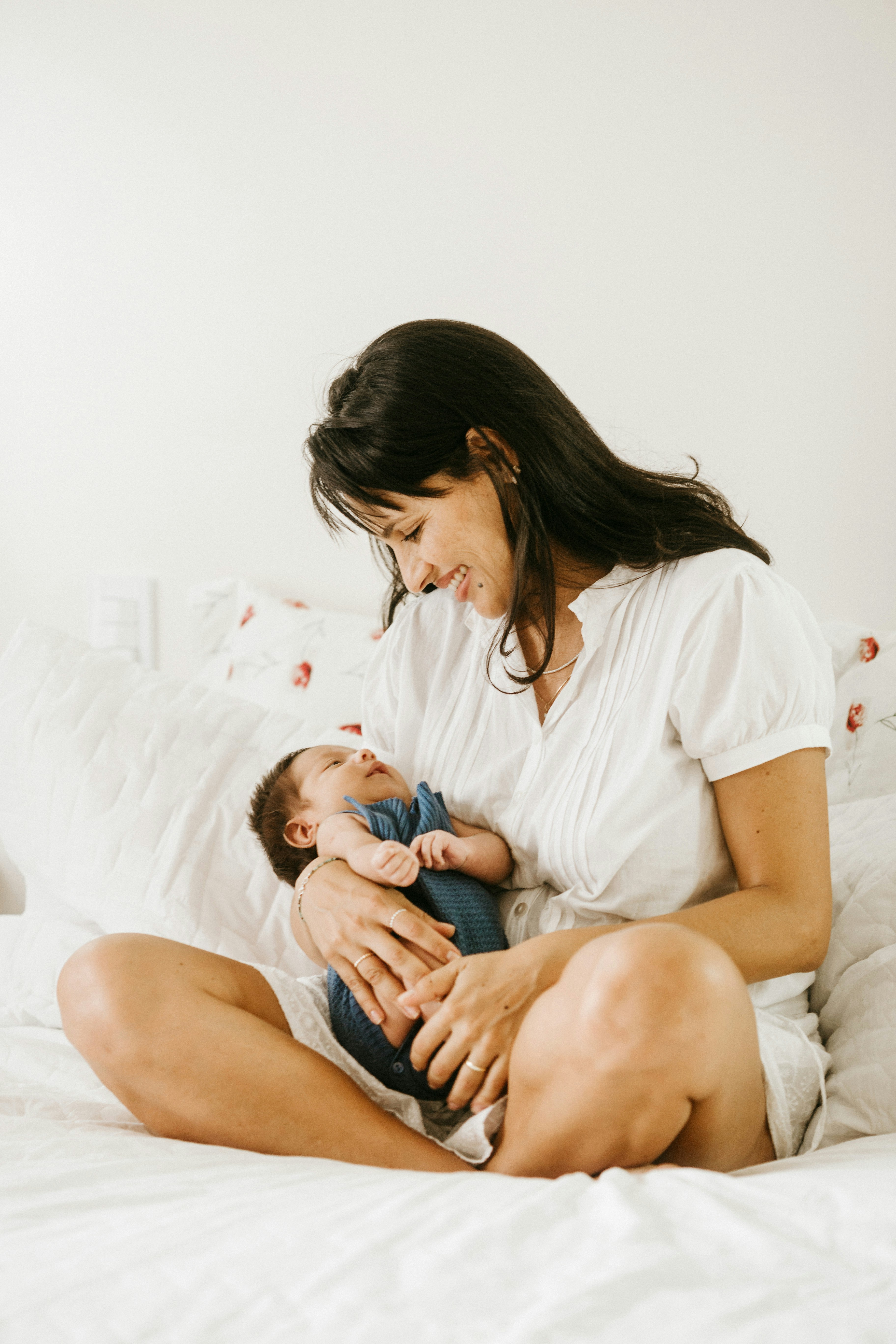 Mother holding newborn baby, first moments after birth
