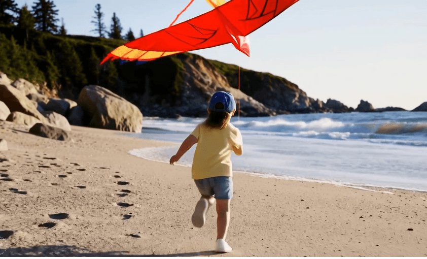 A girl at the beach joyfully running while flying a red kite, aligning with Meta's Movie Gen launch.