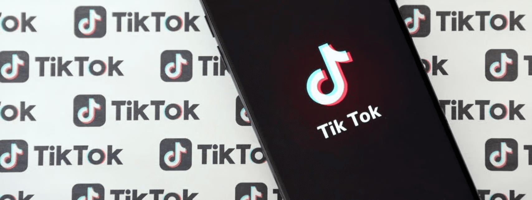 Smartphone showing TikTok logo over logos - Tiktok Content Strategy