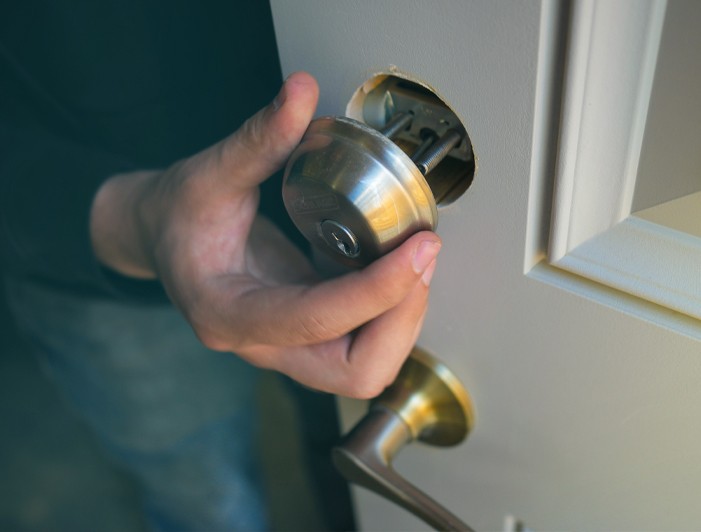 locksmith disassembling deadbolt lock