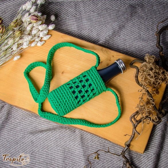 Handcrafted macrame bottle holder in green cotton cord