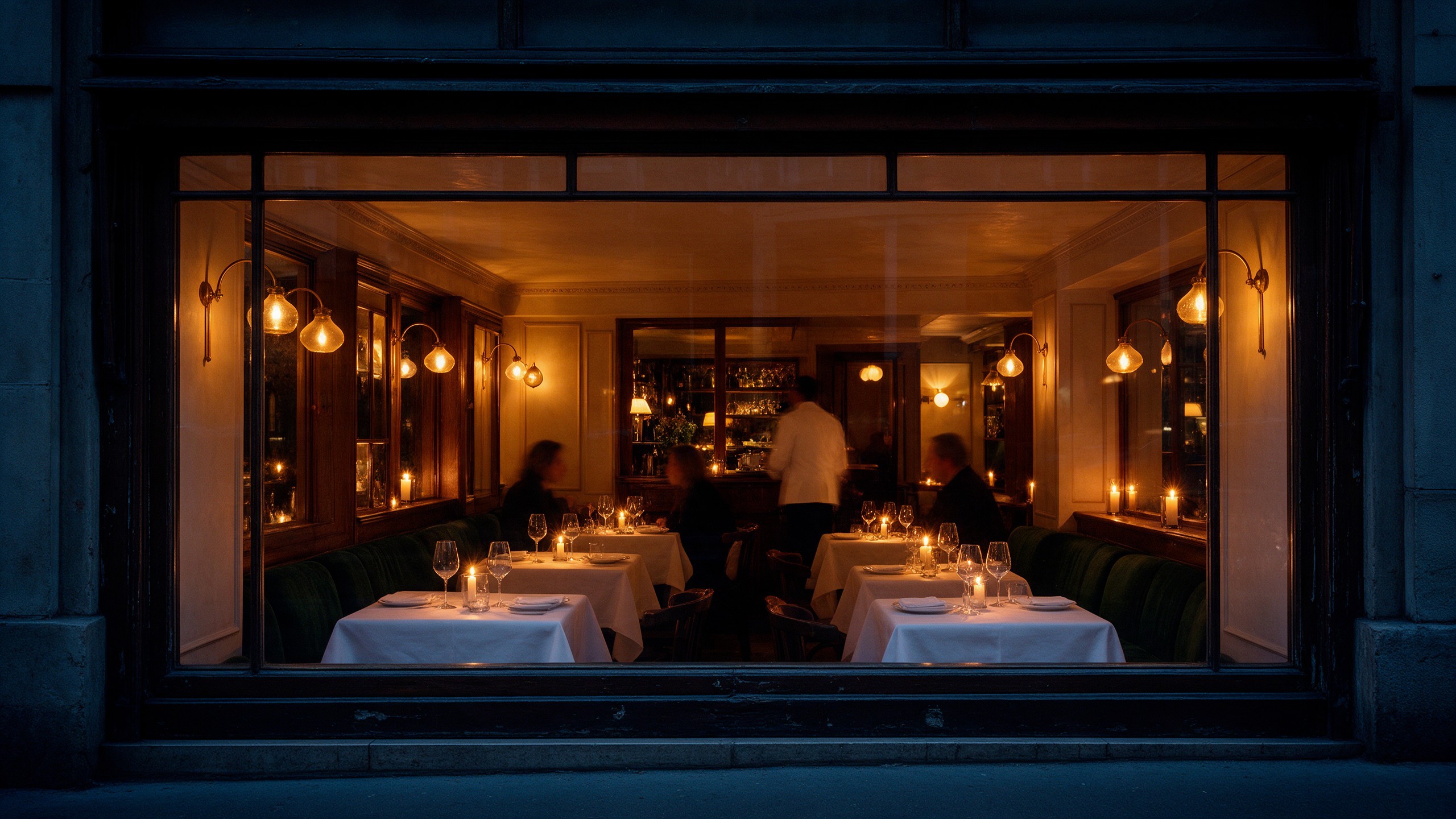 The dining room through the front window at night