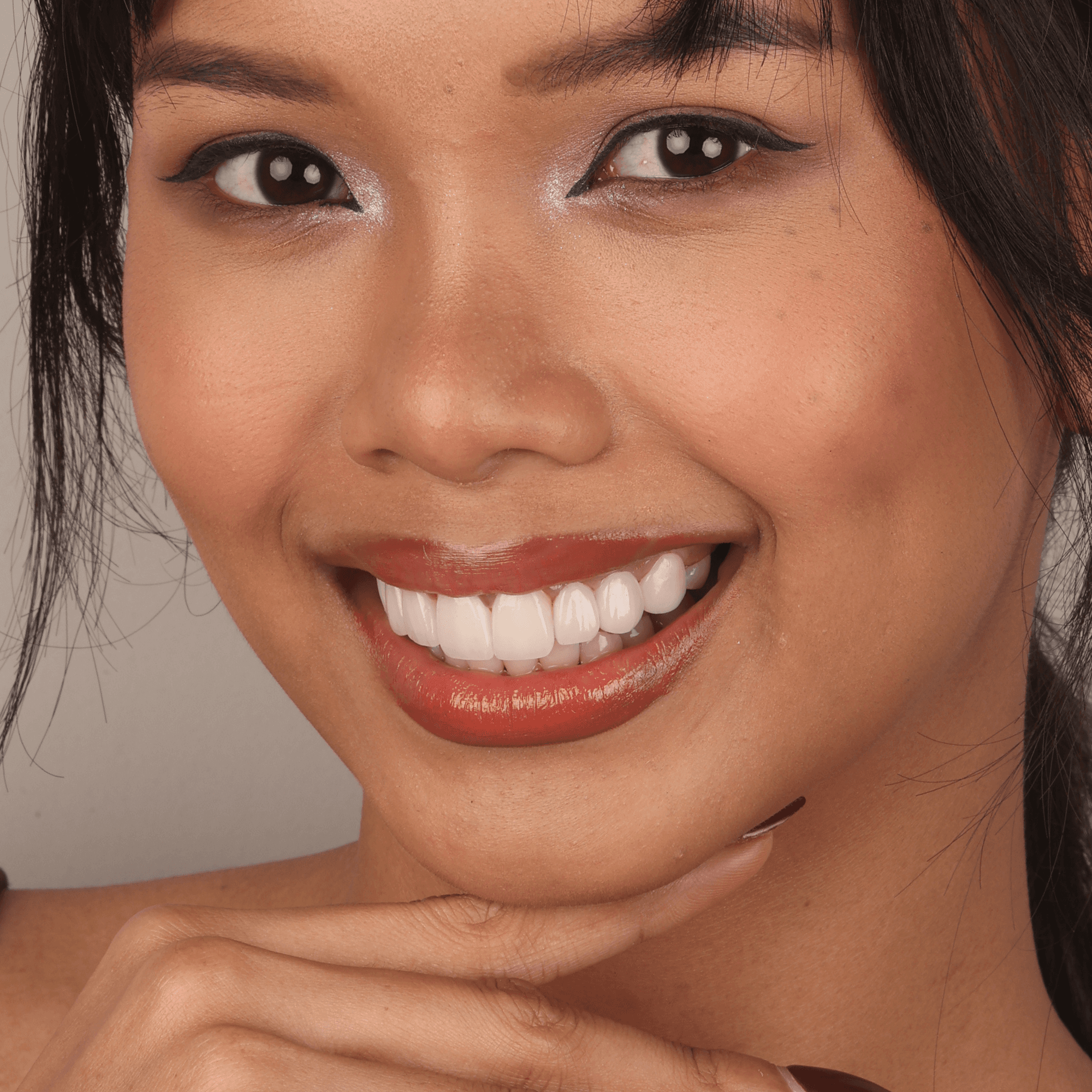 Confident patient smiling with perfectly fitted prosthodontics and high-quality removable dentures by Ora Dental.