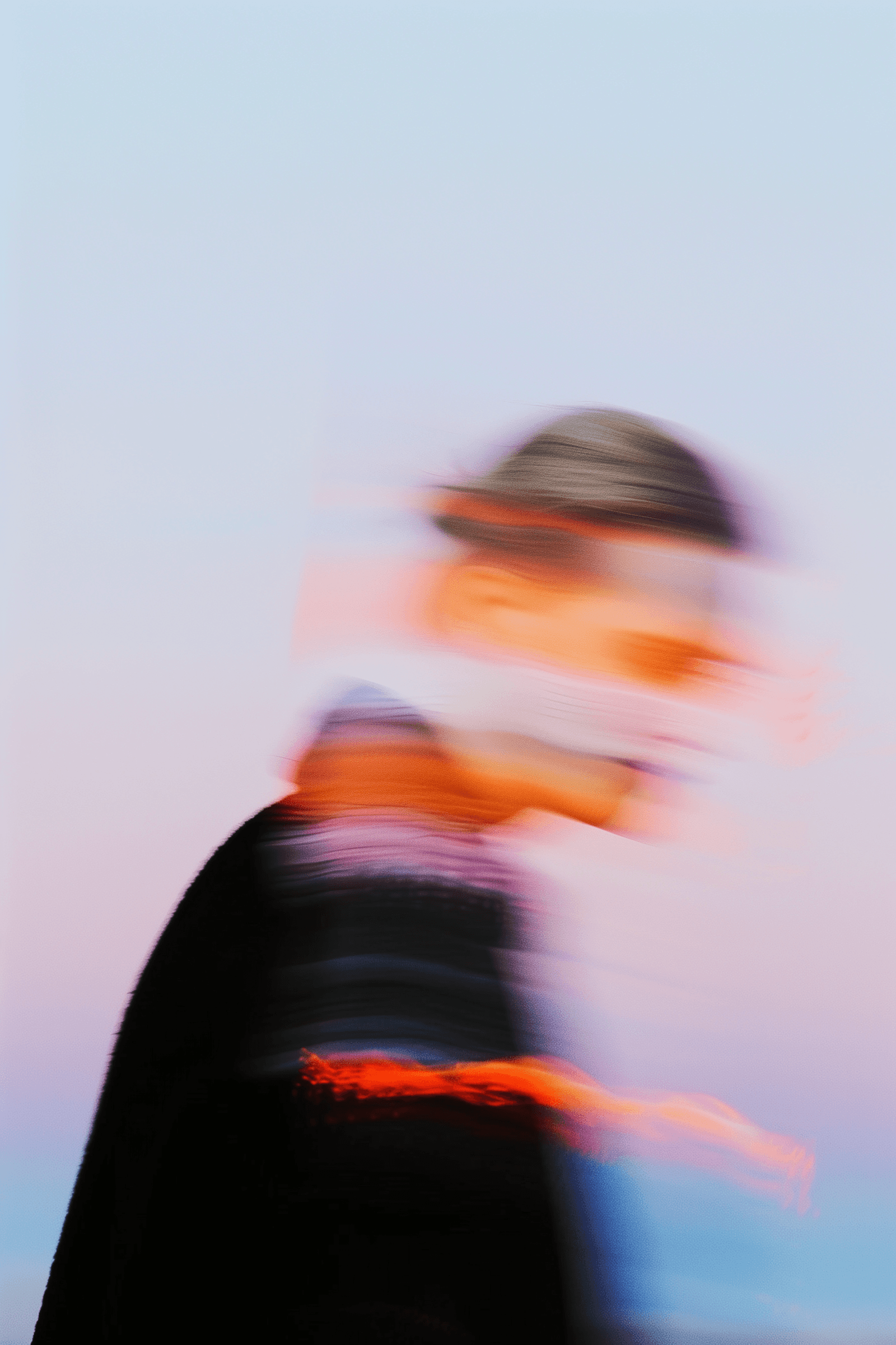 Performer in motion with dark tones, captured from a low angle with dramatic blur.