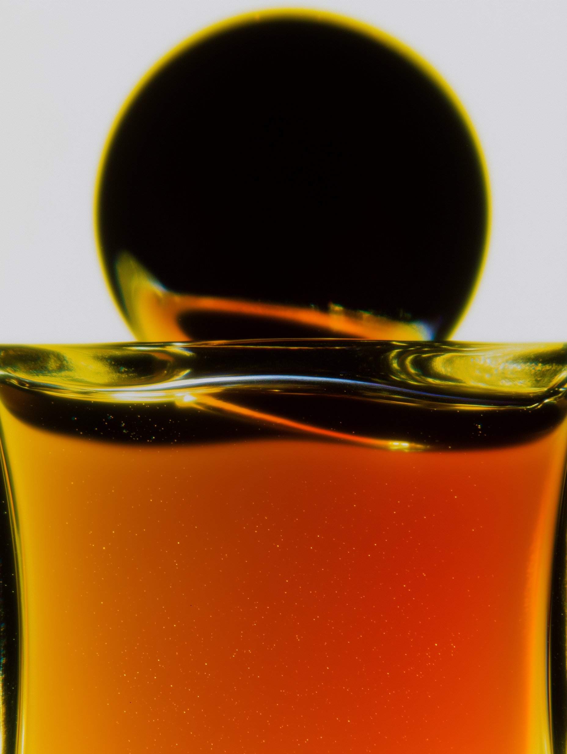 Golden and amber liquid with sparkle effects overhead