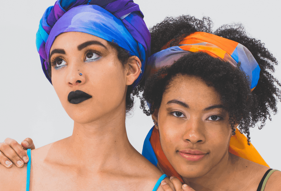 A light brown tag with black string on a peach background displays illustrated symbols for "DEPRESSION," "FEAR," and "LOVE." The text emphasizes the importance of being loud to heal and proud of one's identity.
