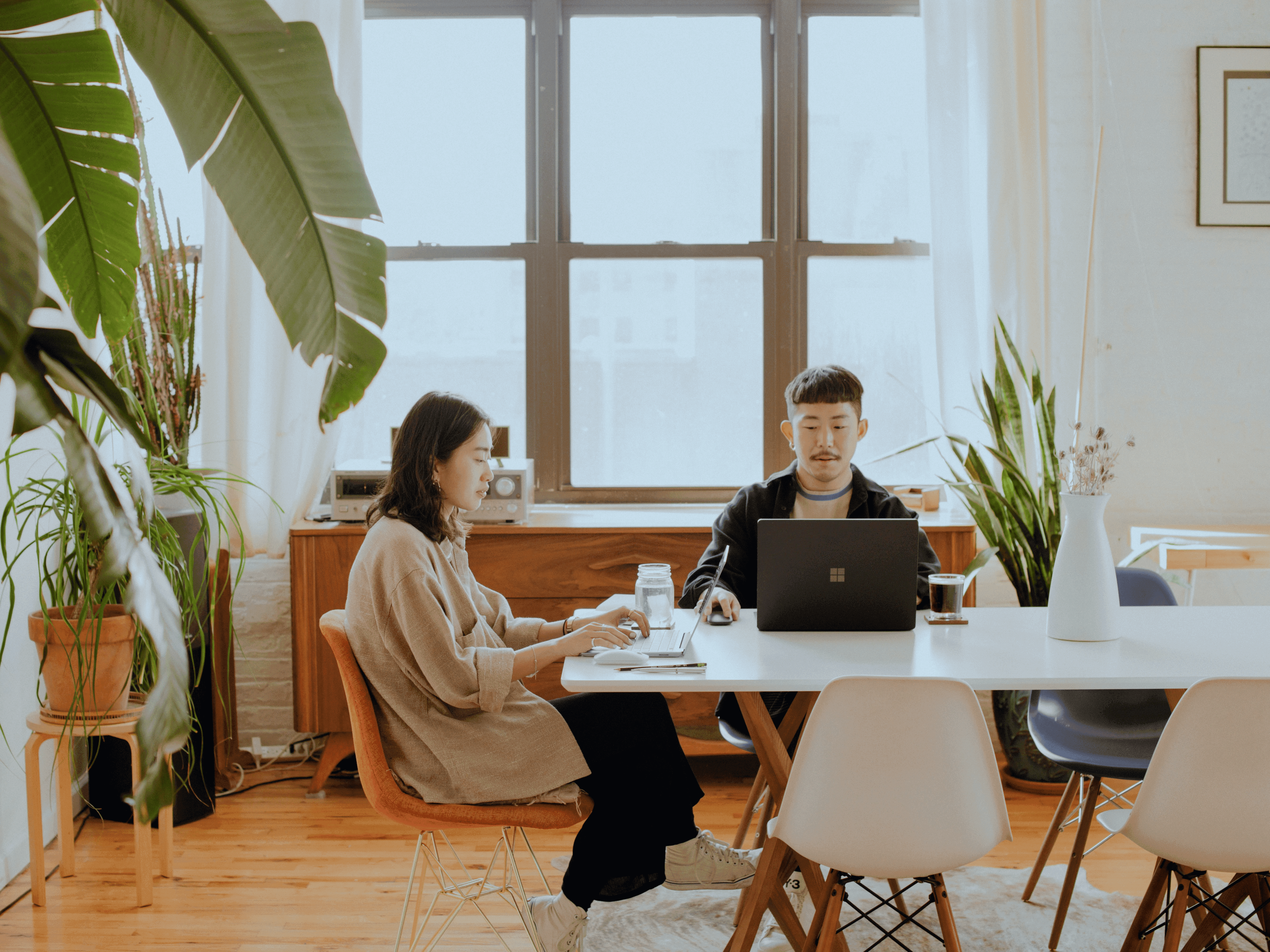 Two people working on laptops in office setting for recruiters highlighting collaboration