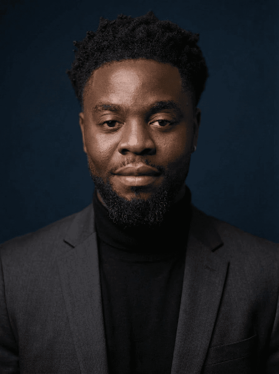 Portrait of a woman with straight long hair, in a dark t-shirt, set against a neutral backdrop.