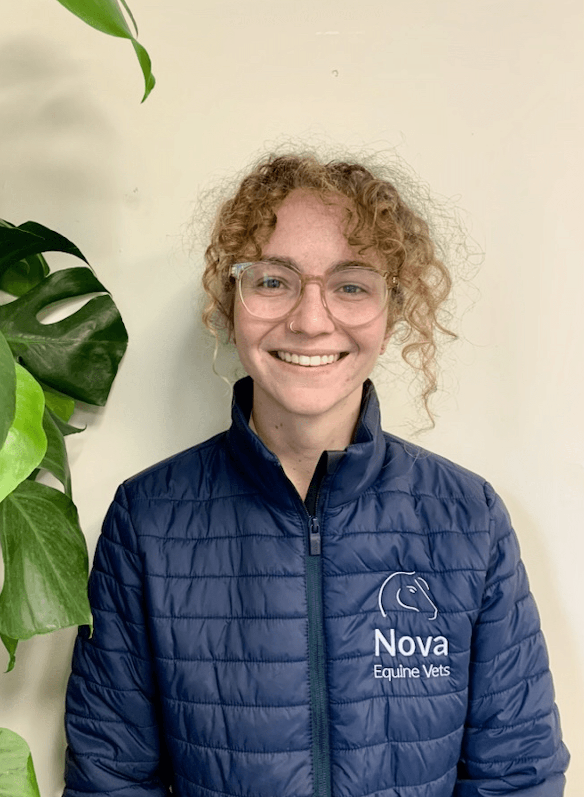 a man in a blue shirt smiling at the camera