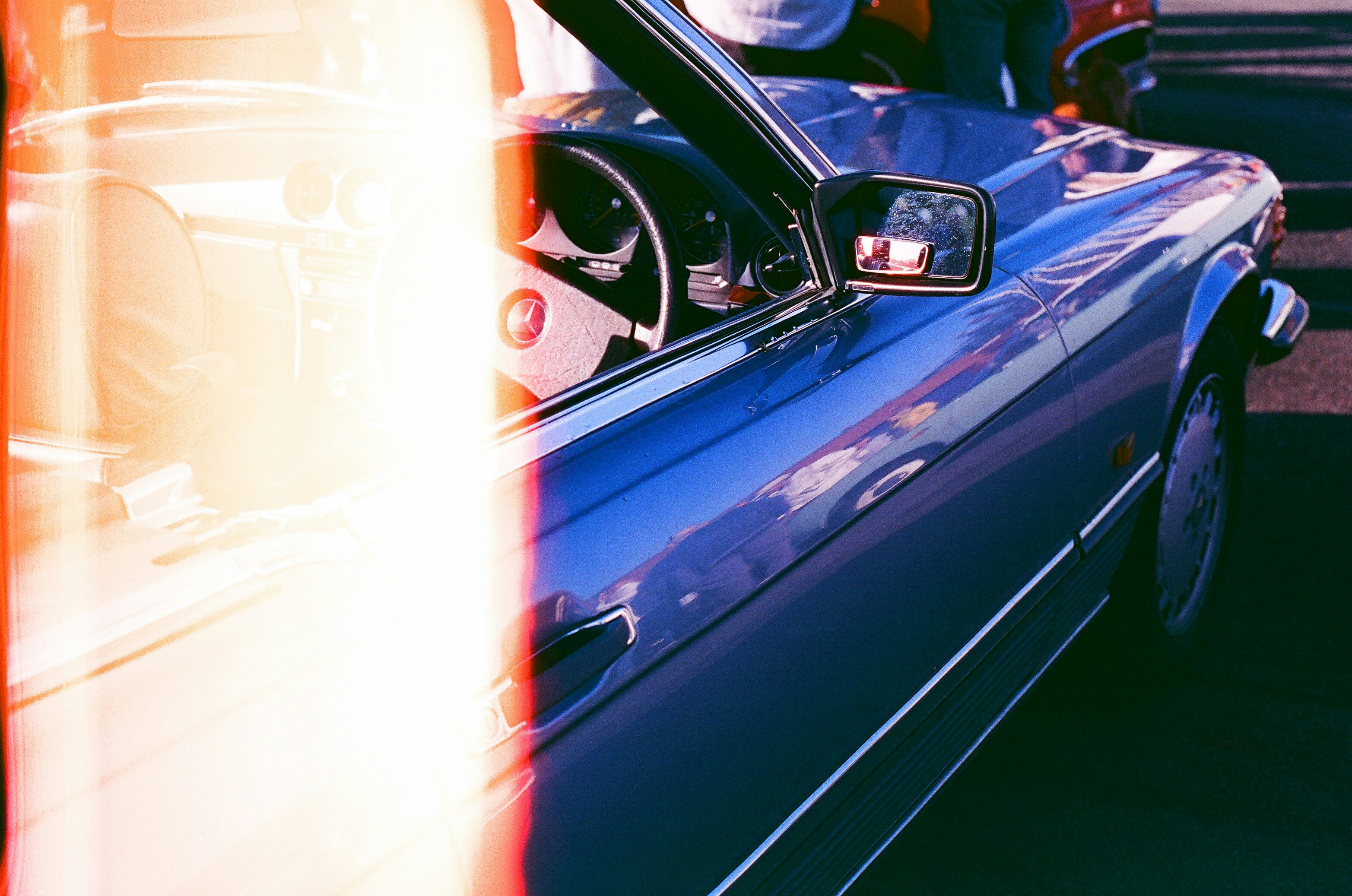 Blue convertible car with vintage film grain effect