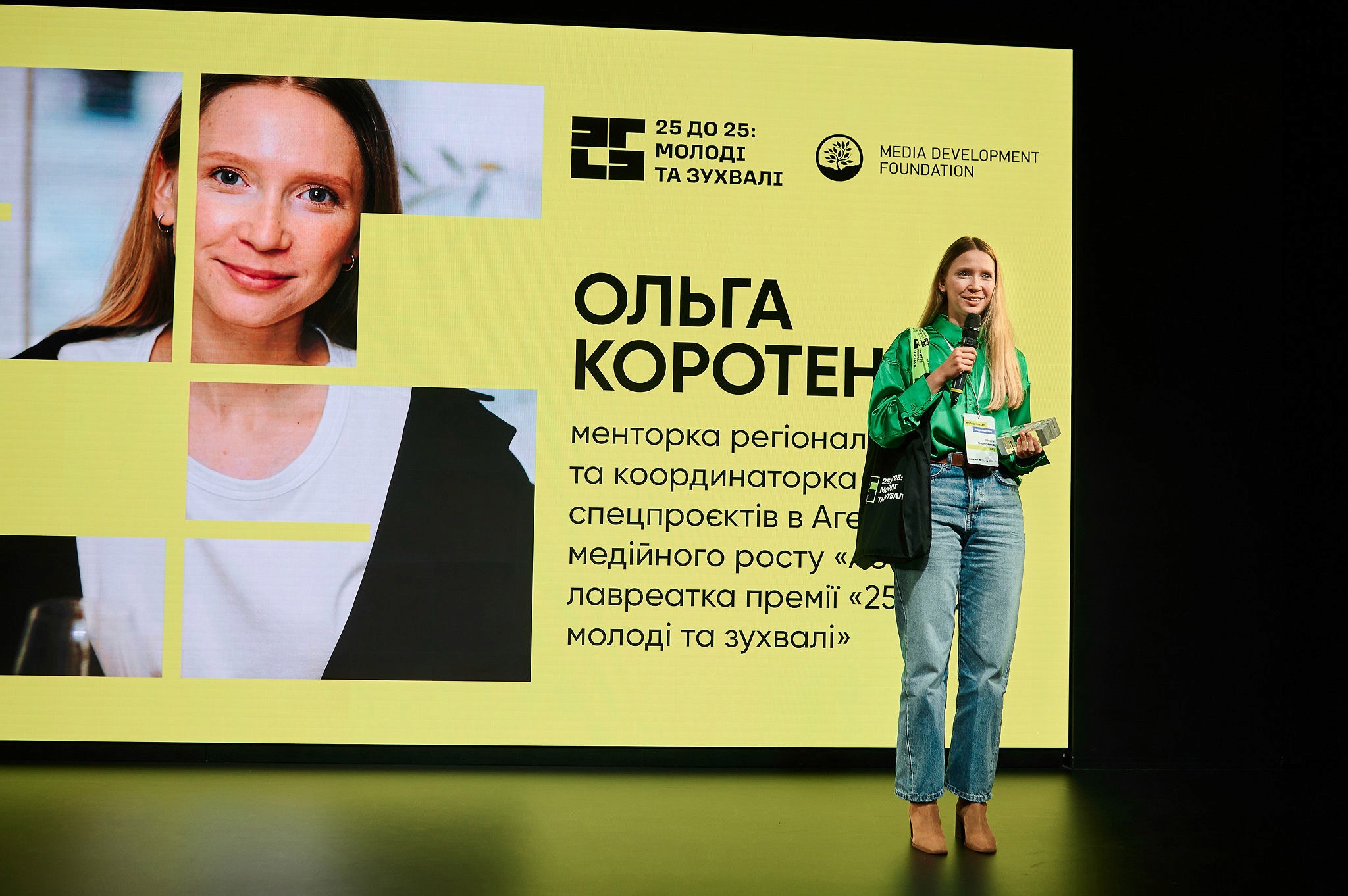 AI conference speakers demonstrating hands-on product work during a live session on stage.