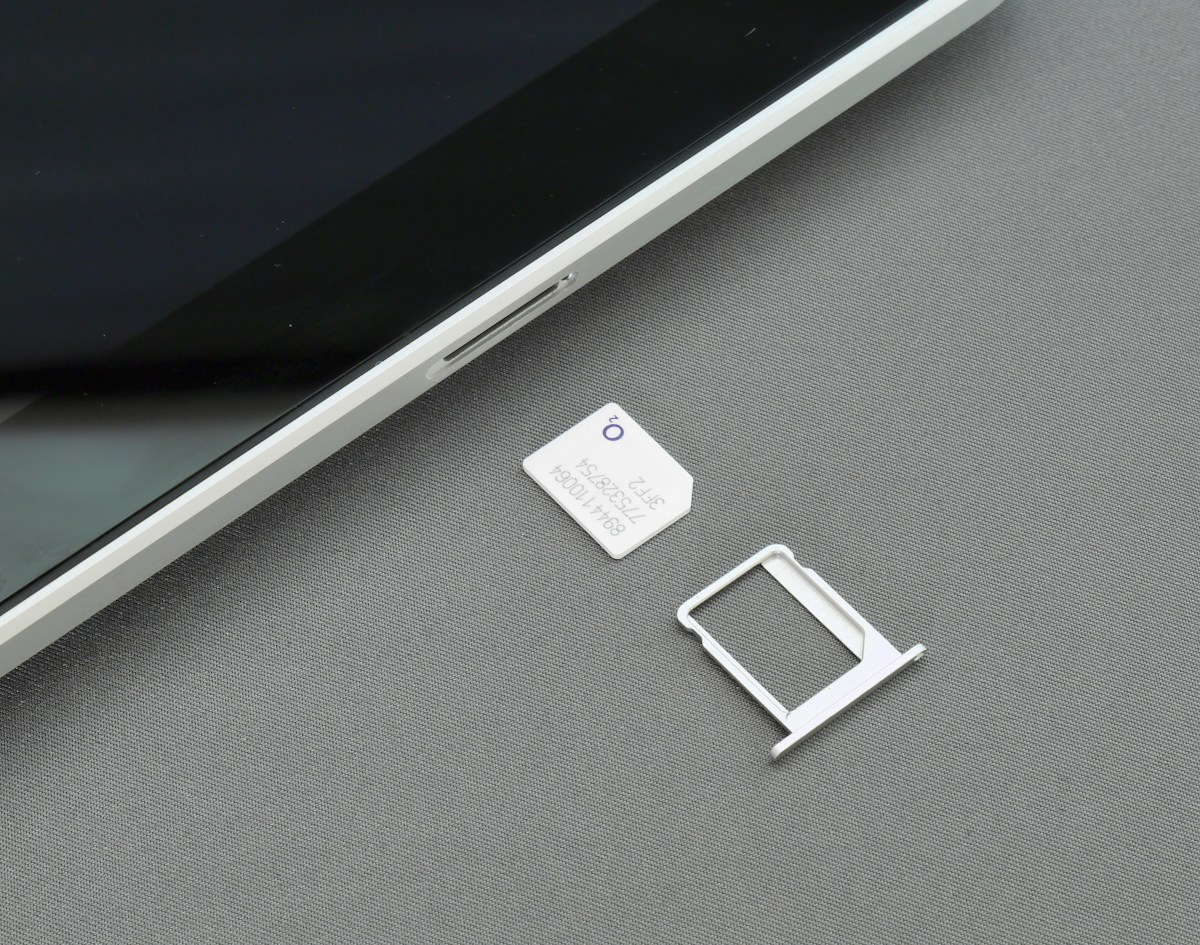 Close-up of a smartphone's SIM tray slot on its edge