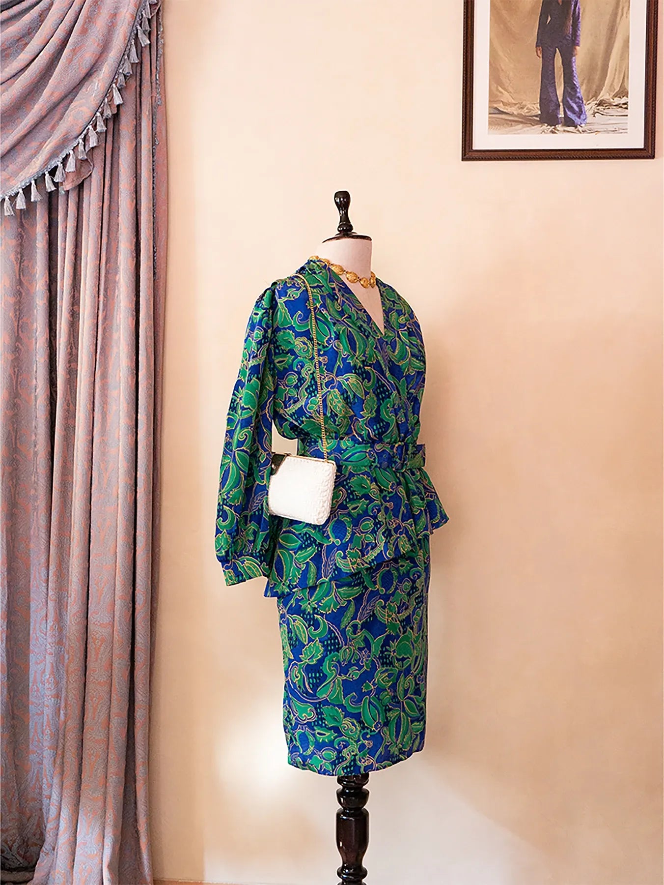 Vintage green and blue paisley print two-piece set with structured top and pencil skirt.